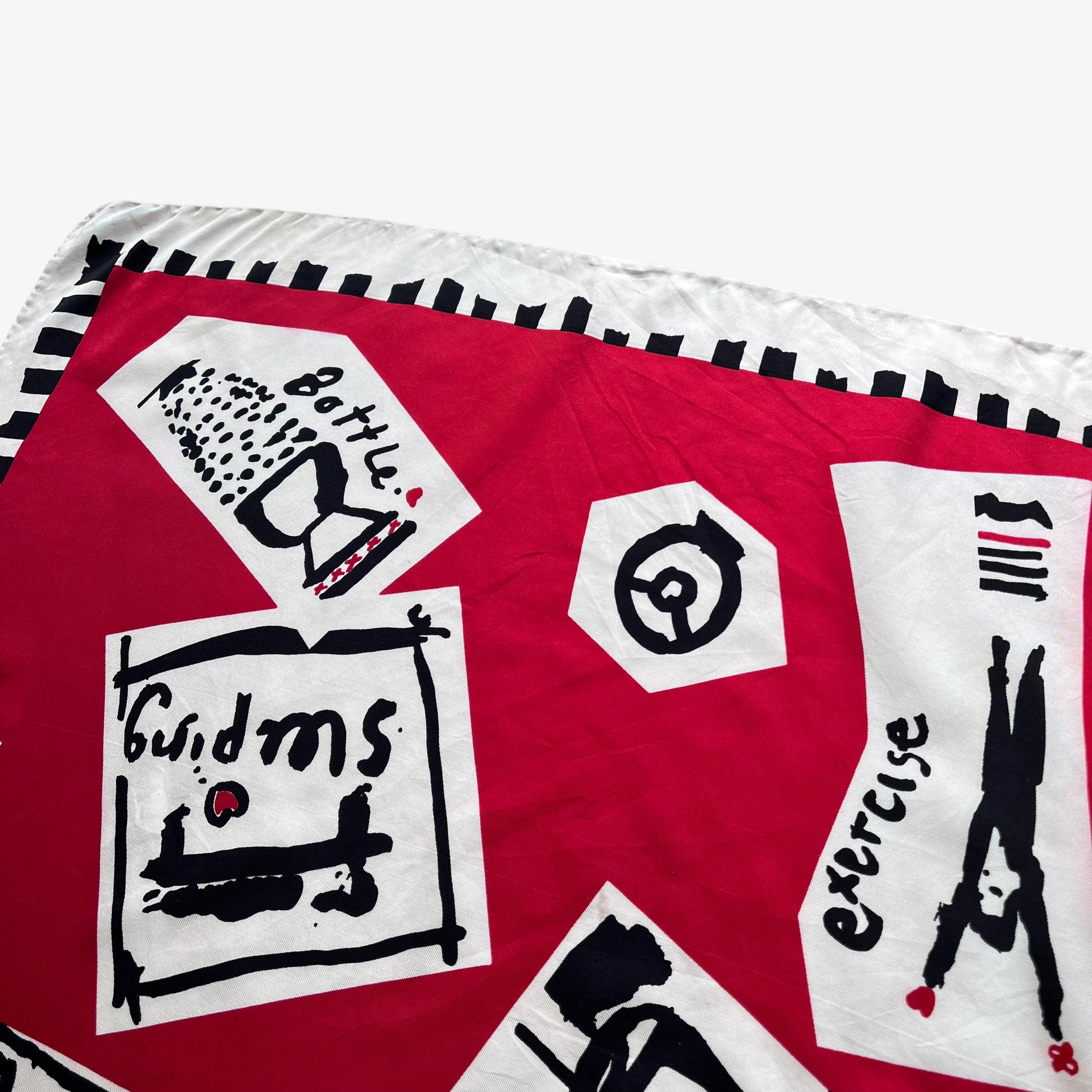 Patterned print of women's vintage 80s Paloma Picasso red silk scarf featuring the famous a day in the life of a woman design.