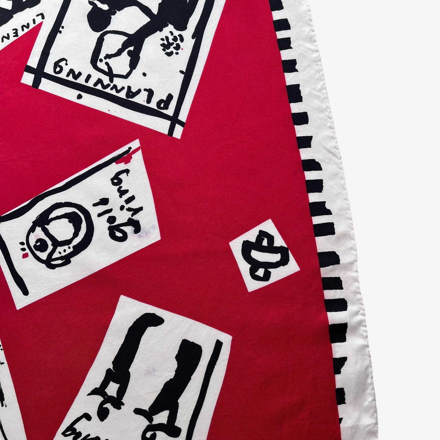 Vibrant red patterned of women's vintage 80s Paloma Picasso silk scarf featuring the famous a day in the life of a woman design.