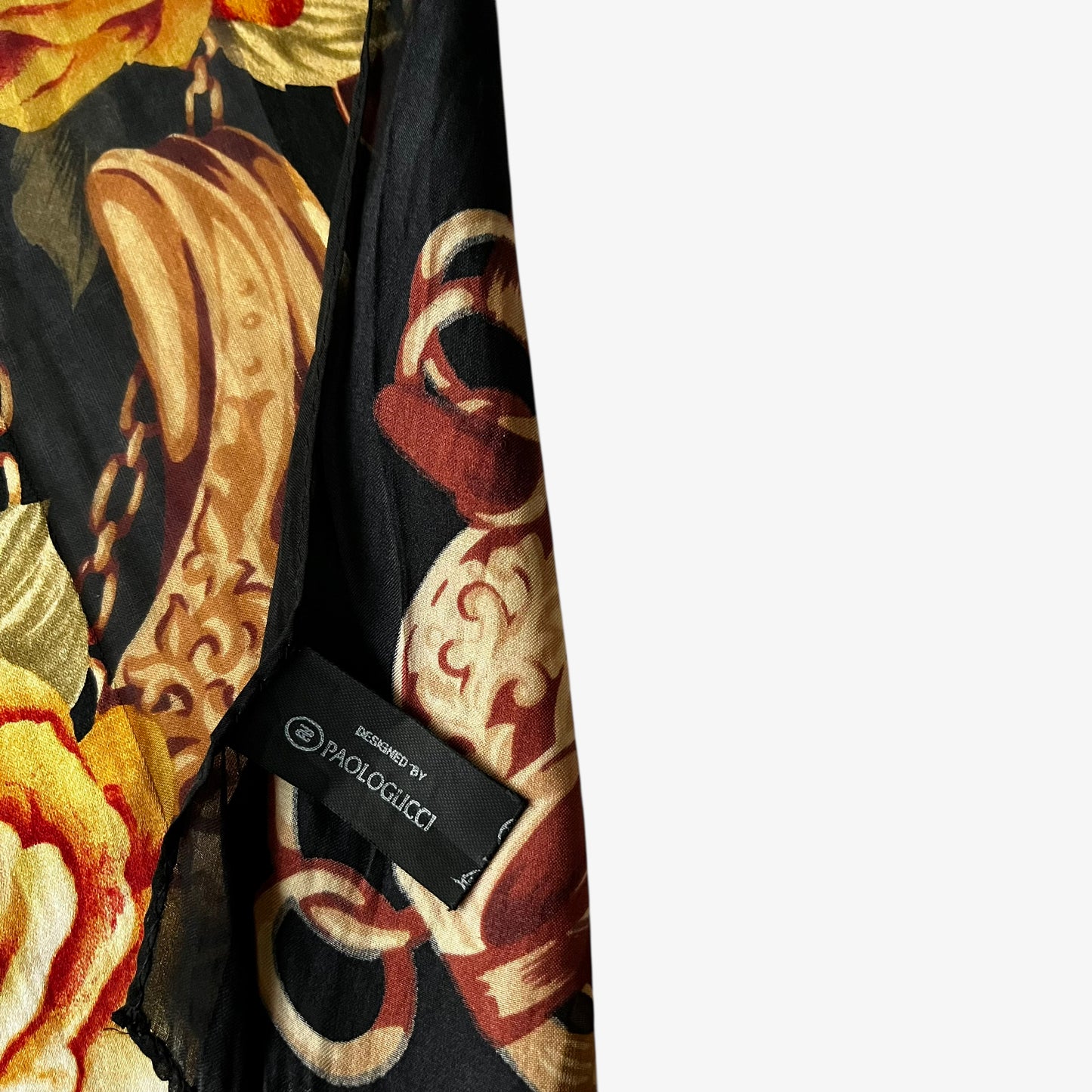 Paolo Gucci label on a women's vintage 80s black silk scarf featuring a checkered floral and equestrian buckle print.