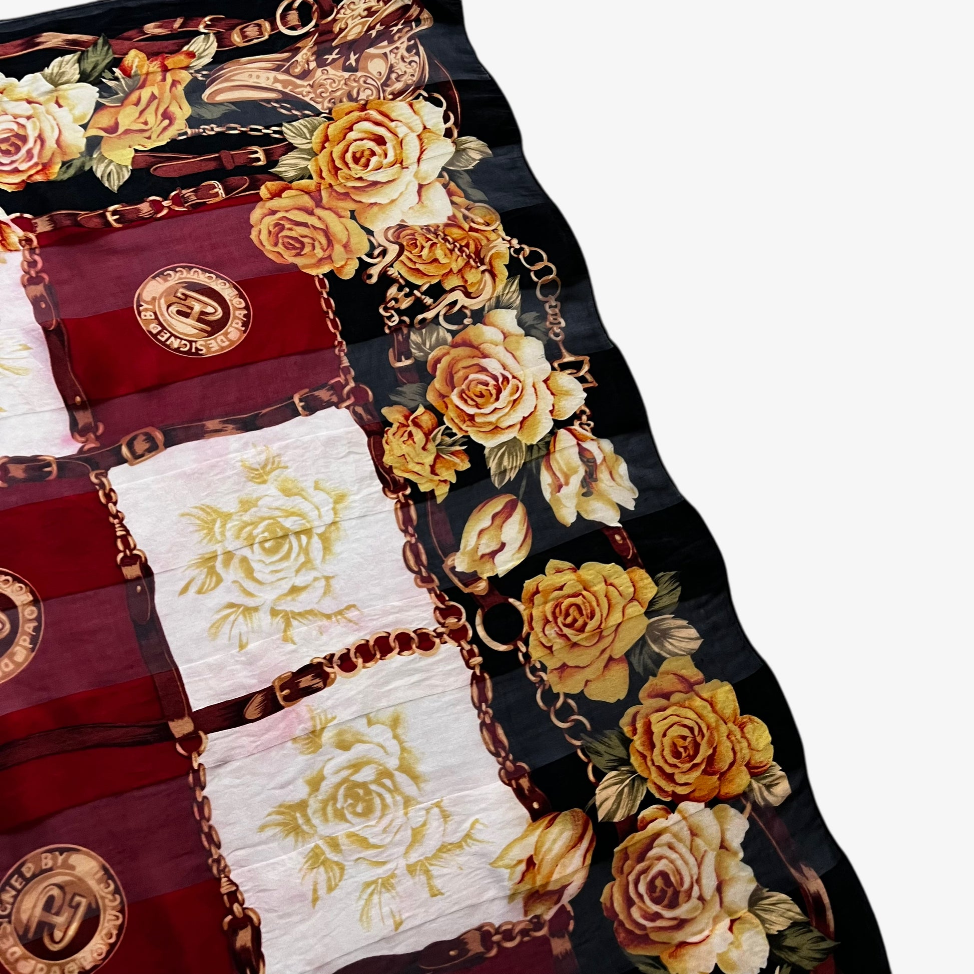 Slight red colour run on the corner of a women's vintage 80s Paolo Gucci black silk scarf featuring a checkered floral and equestrian buckle print.