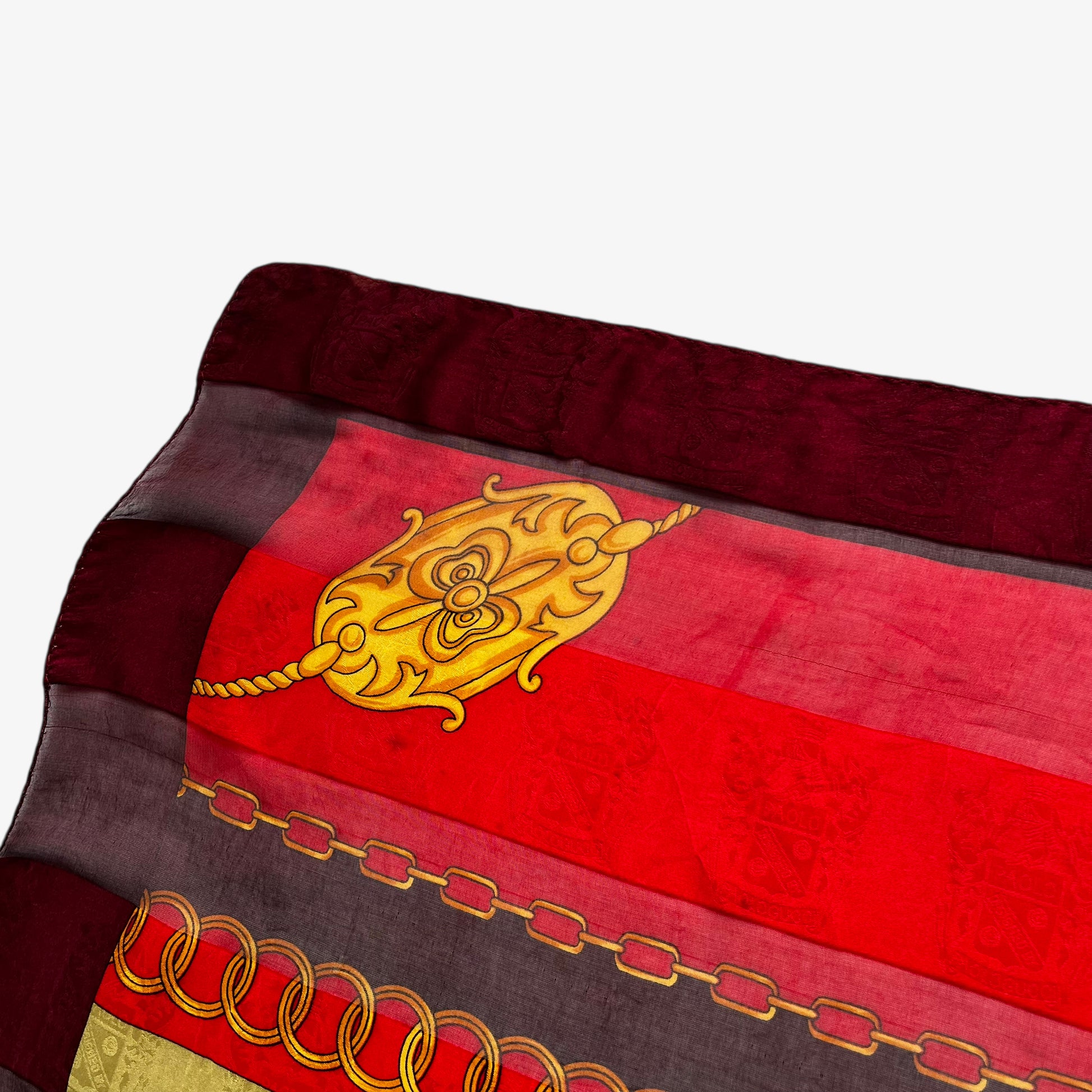 Jewel emblem on vintage 80s women's Paolo Gucci equestrian buckle and embossed crest print silk scarf featuring a green and red stripe.