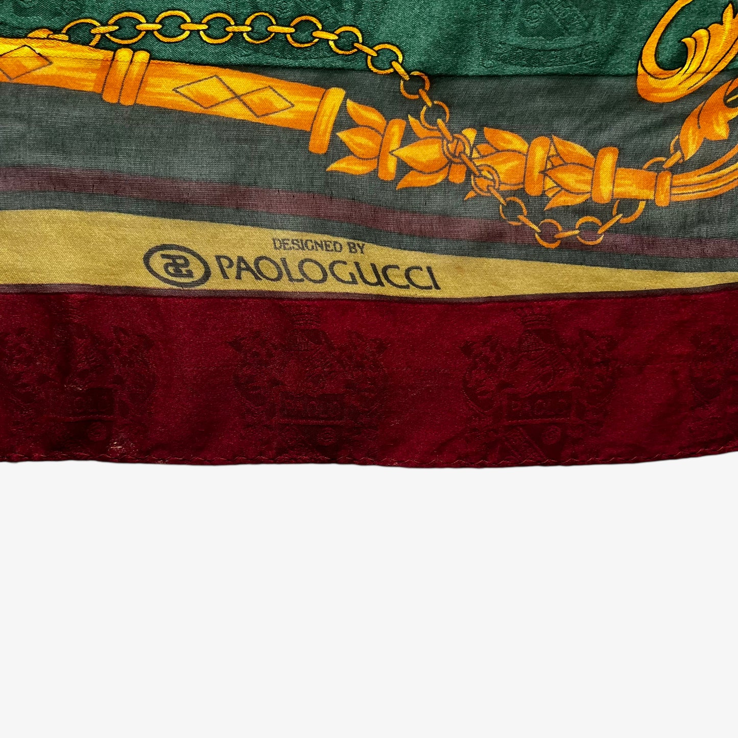 Paolo Gucci spell out logo on vintage 80s women's equestrian buckle and embossed crest print silk scarf featuring a green and red stripe.