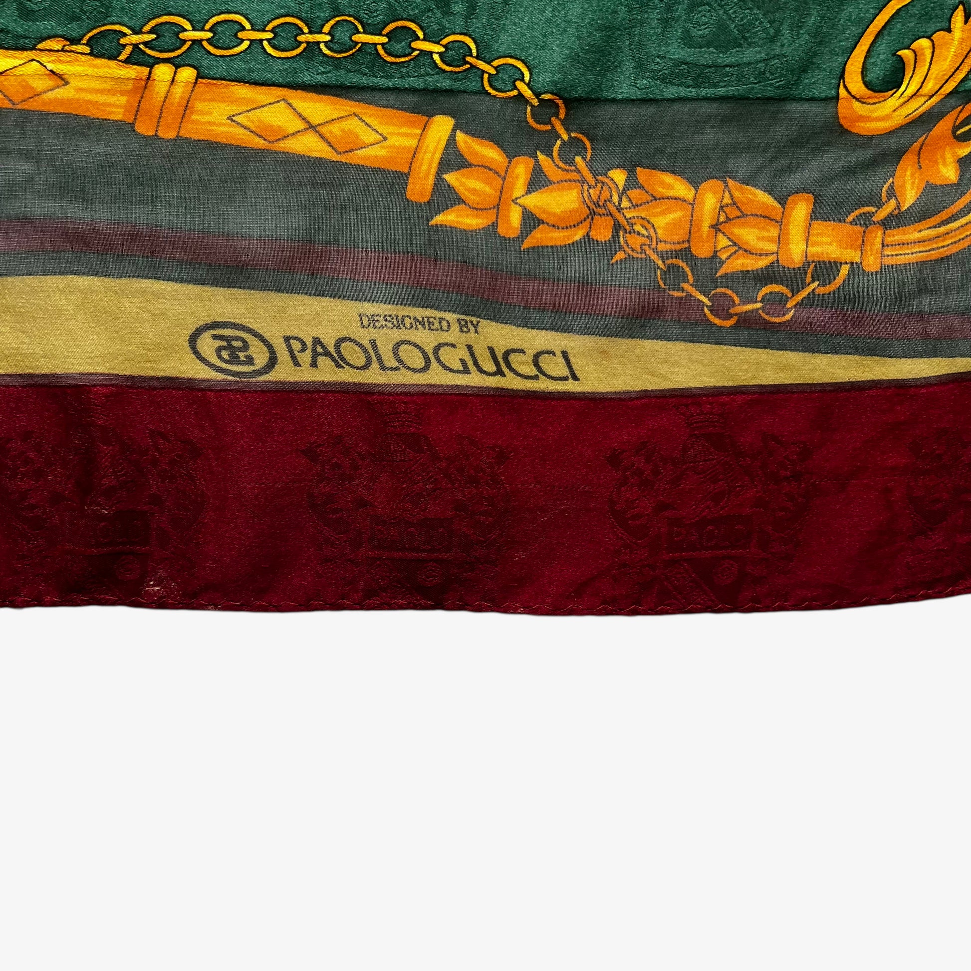 Paolo Gucci spell out logo on vintage 80s women's equestrian buckle and embossed crest print silk scarf featuring a green and red stripe.