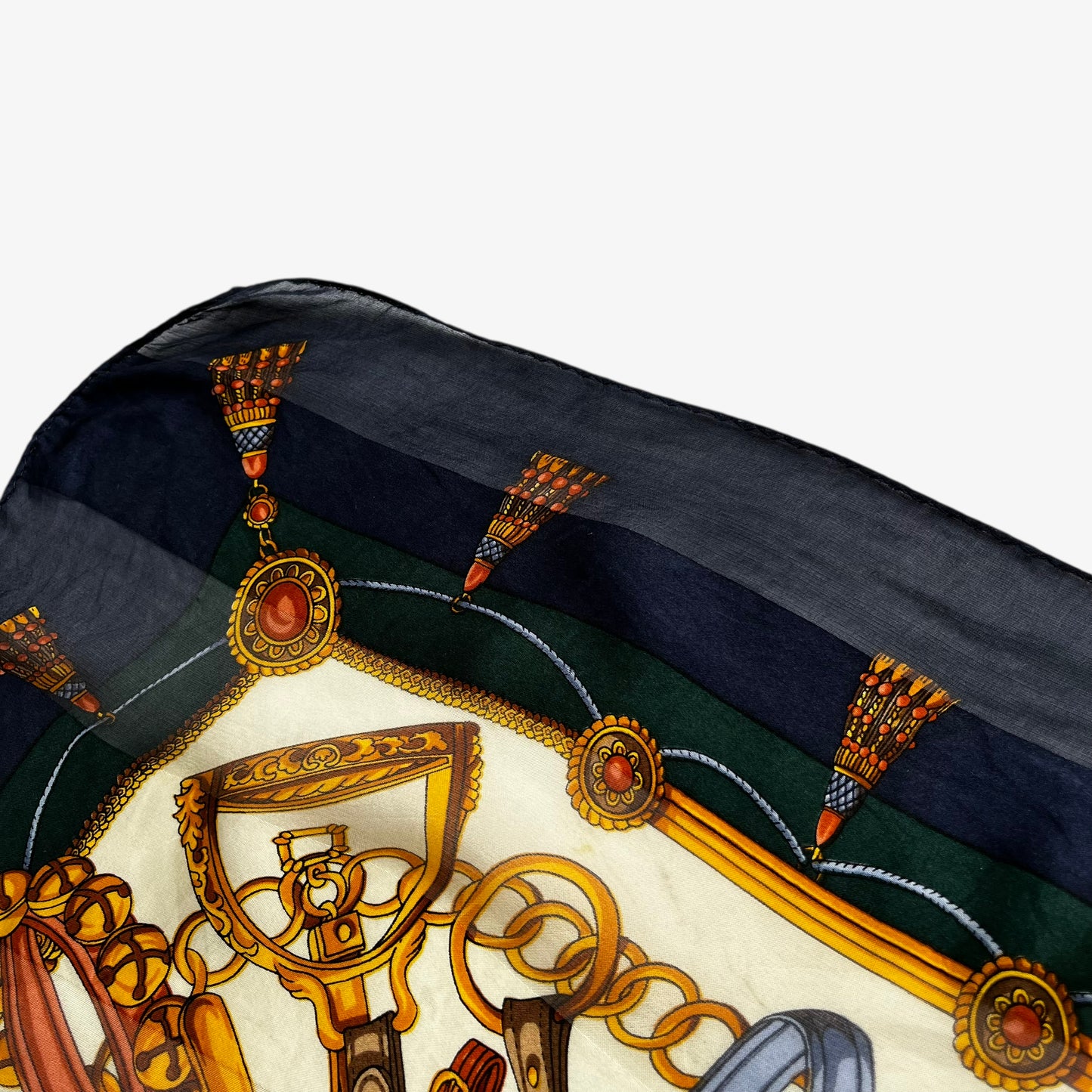 Hem of women's vintage 90s Paolo Gucci equestrian saddle and horsebit print silk scarf.