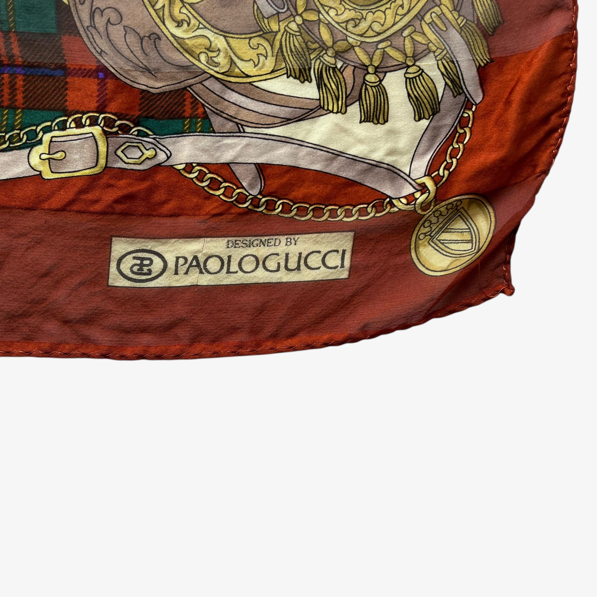 Paolo Gucci spell out logo on women's vintage 80s equestrian saddle print red silk scarf featuring a green tartan stripe.