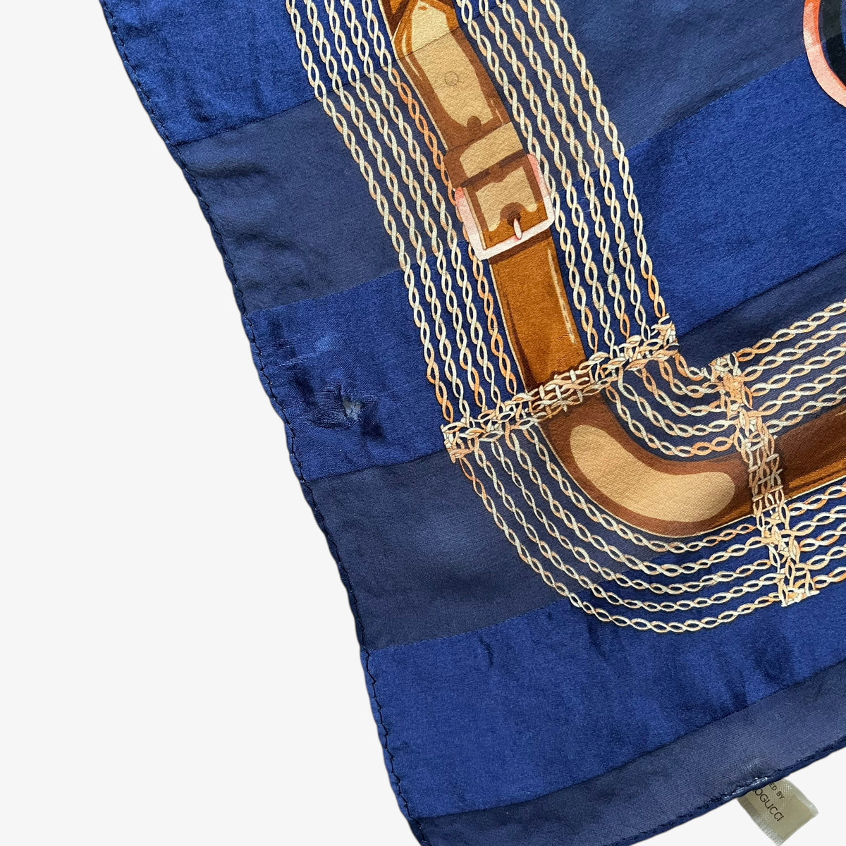 Patina on the corner of a vintage 80s women's Paolo Gucci pink horsebit and brown equestrian strap print navy silk scarf.