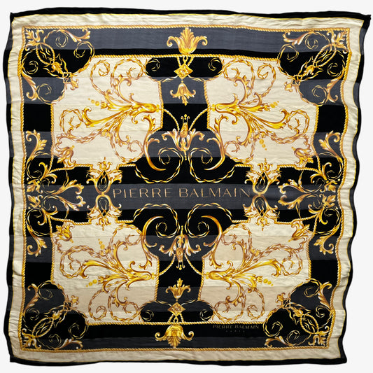 Vintage 80s women's Pierre Balmain gold baroque spell out print black silk scarf.