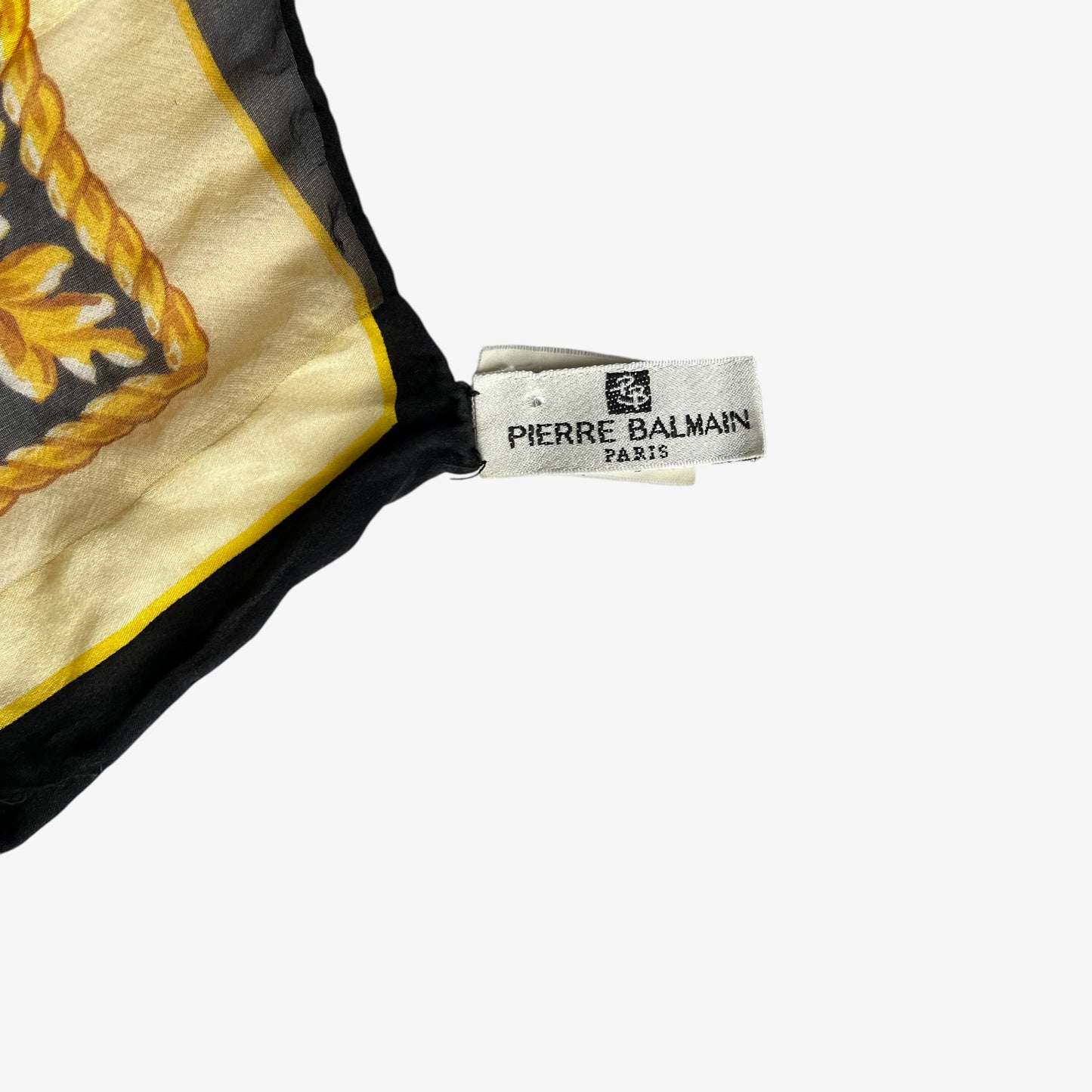 Pierre Balmain Paris label on vintage 80s women's gold baroque spell out print black silk scarf.
