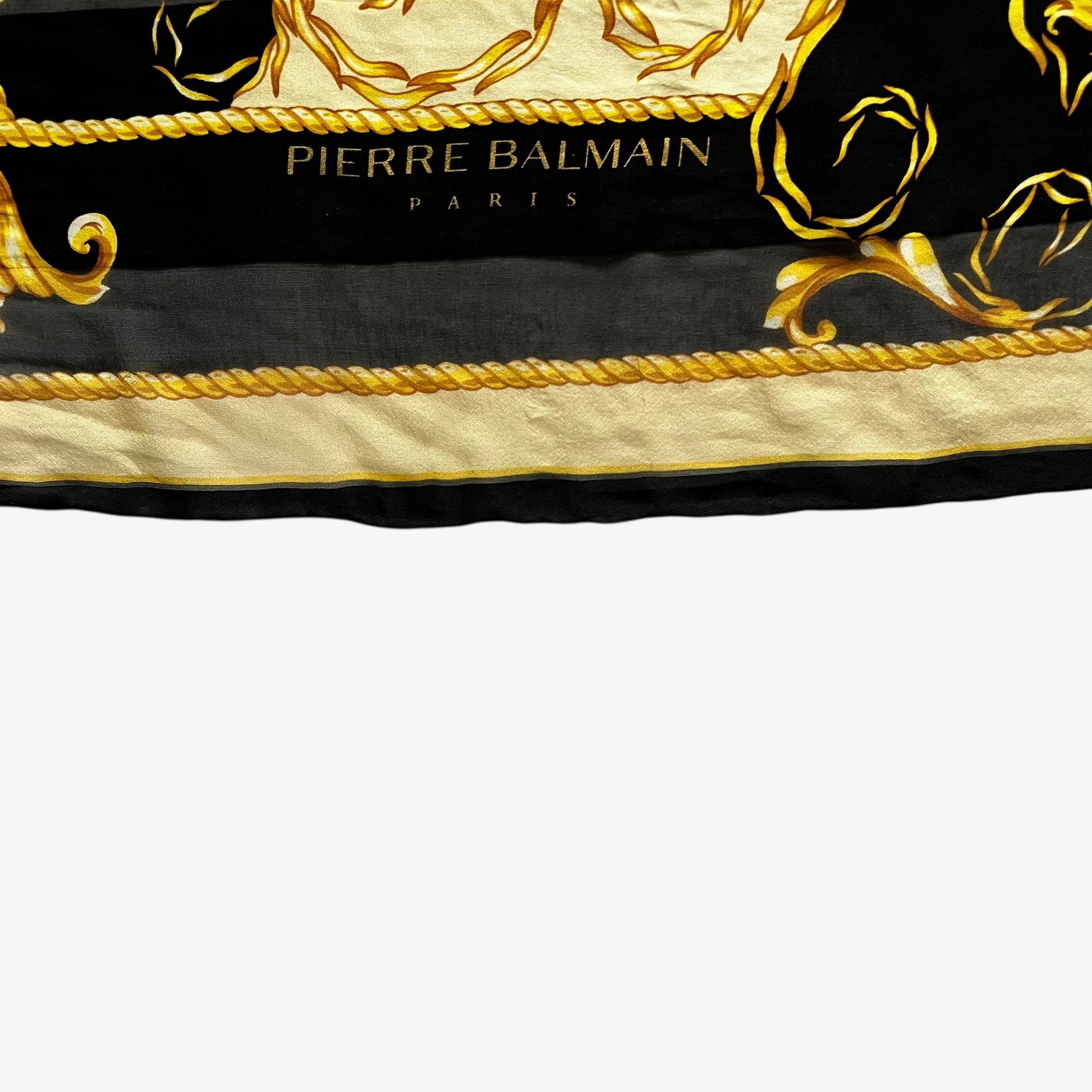 Pierre Balmain Paris spell out logo on vintage 80s women's gold baroque print black silk scarf.
