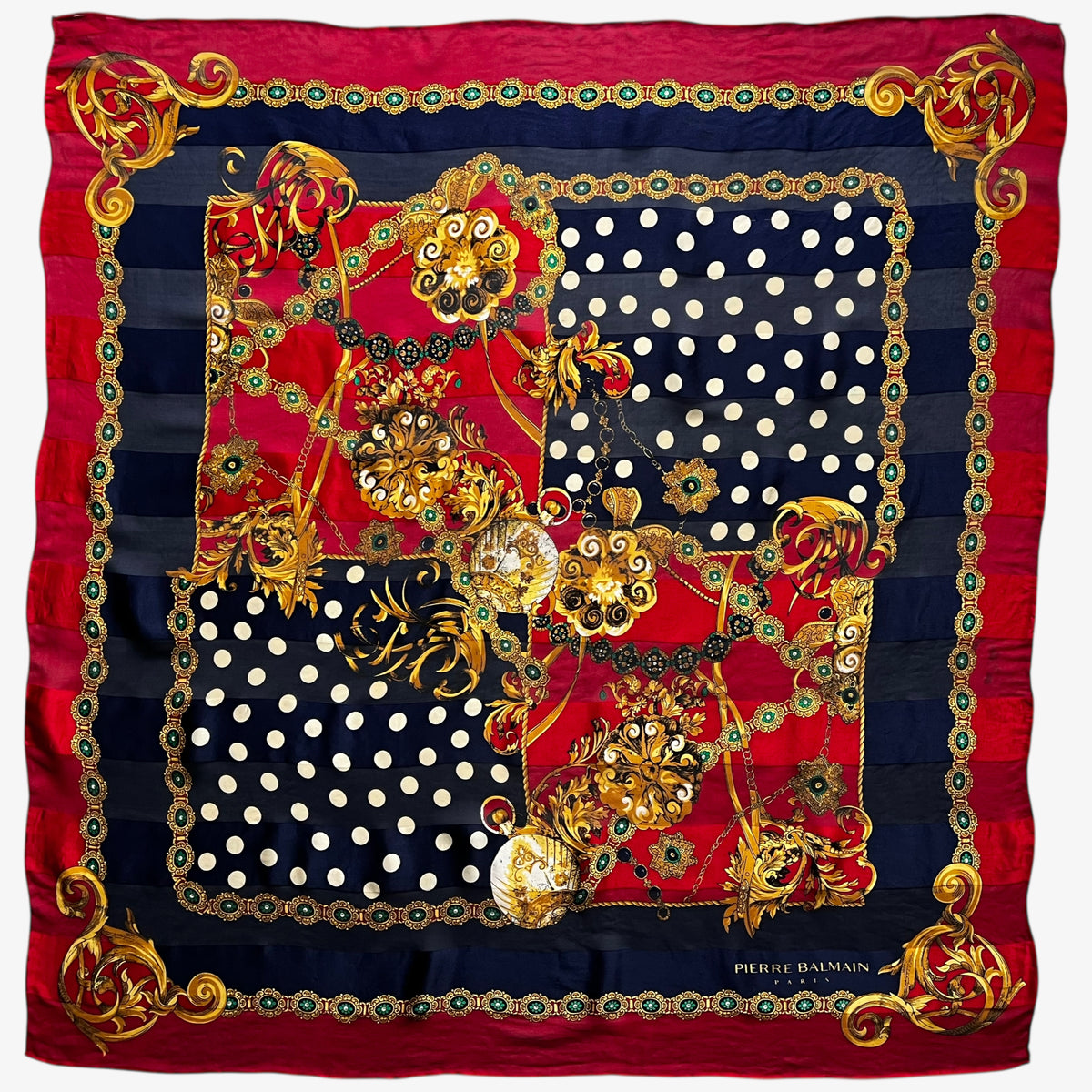 Women's vintage 80s Pierre Balmain silk scarf featuring a gold royal medallion and polka dot print.