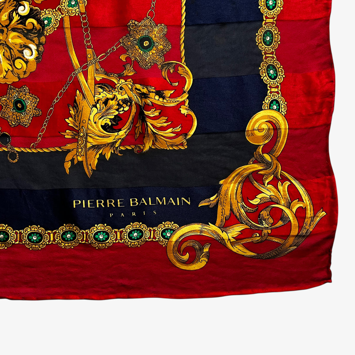 Pierre Balmain Paris spell out logo on a women's vintage 80s silk scarf featuring a gold royal medallion and polka dot print.