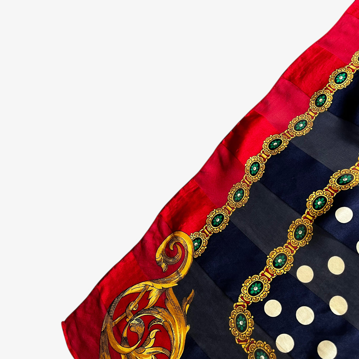 Discreet striped design on a women's vintage 80s Pierre Balmain silk scarf featuring a gold royal medallion and polka dot print.