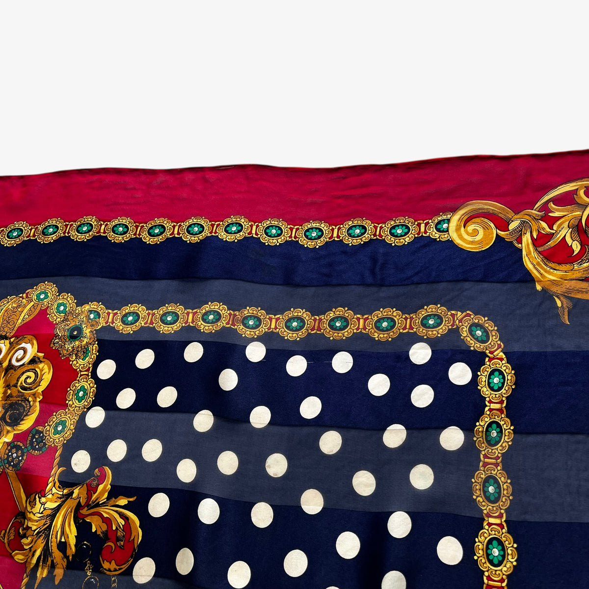 Patina on a women's vintage 80s Pierre Balmain silk scarf featuring a gold royal medallion and polka dot print.