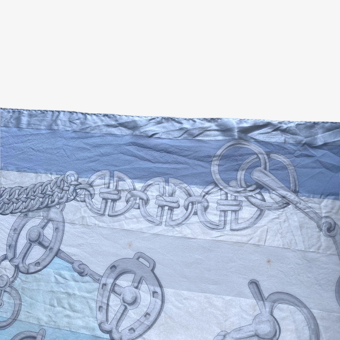 Patina on women's vintage 90s Pierre Balmain Paris geometric horsebit print blue silk scarf.