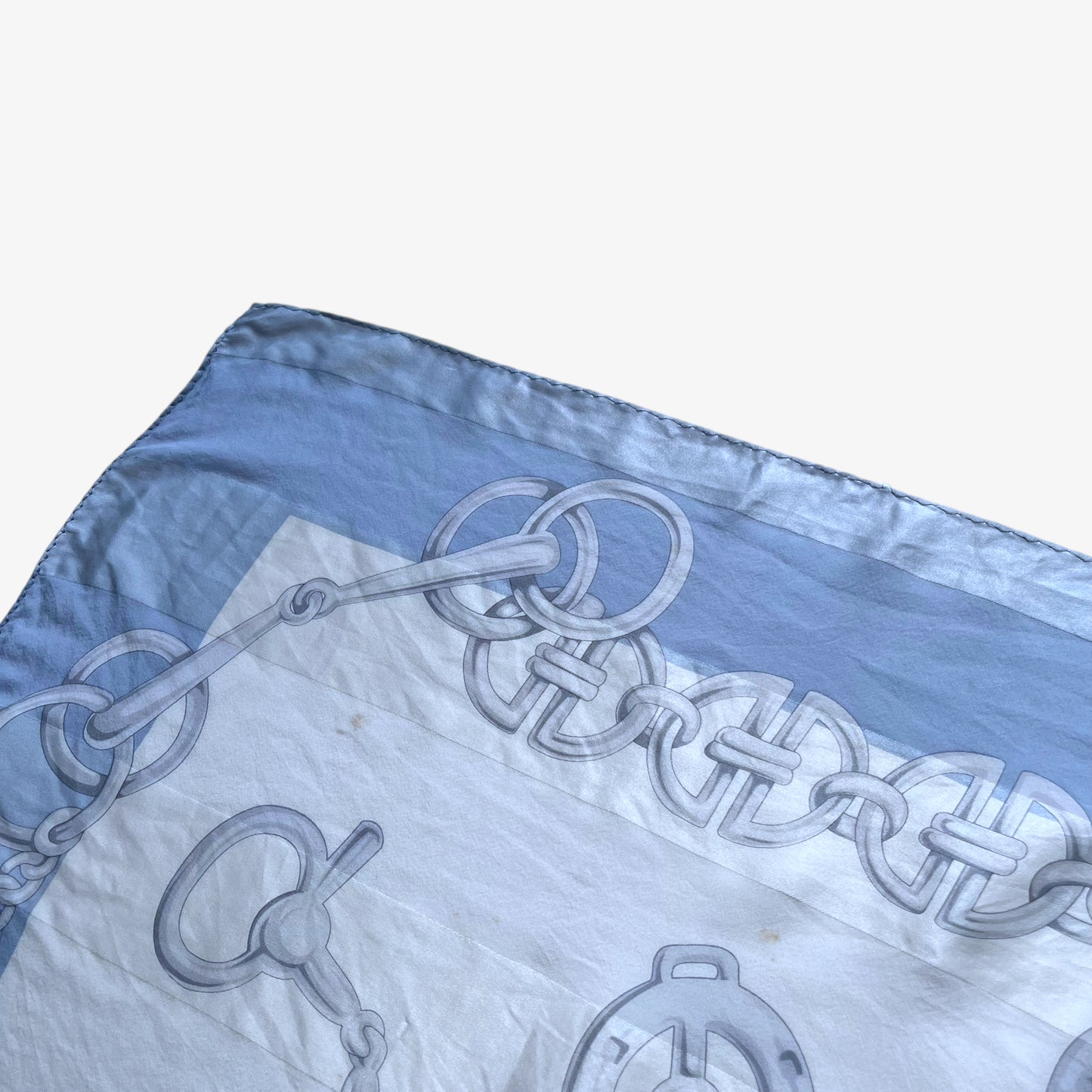 General wear on women's vintage 90s Pierre Balmain Paris geometric horsebit print blue silk scarf.