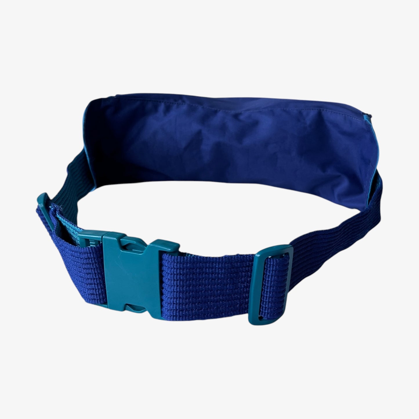 Back view of extra large vintage Salomon blue bum bag with a strap on a white background.