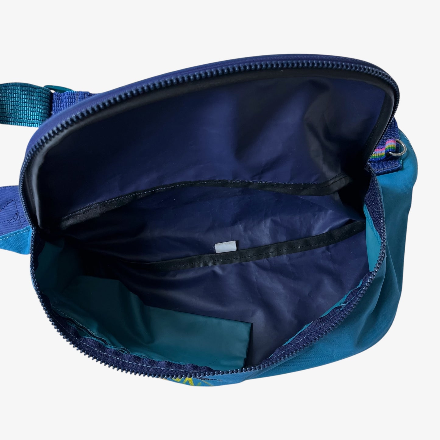 Vintage Salomon blue bum bag with open front pocket on a white background.
