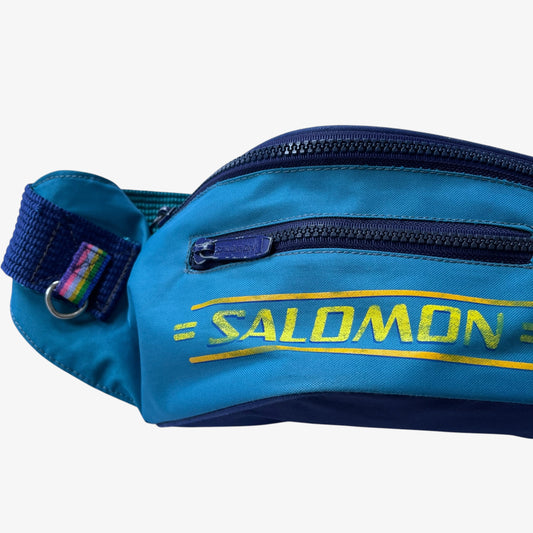 Blue extra large bum bag with yellow Salomon logo on a white background.