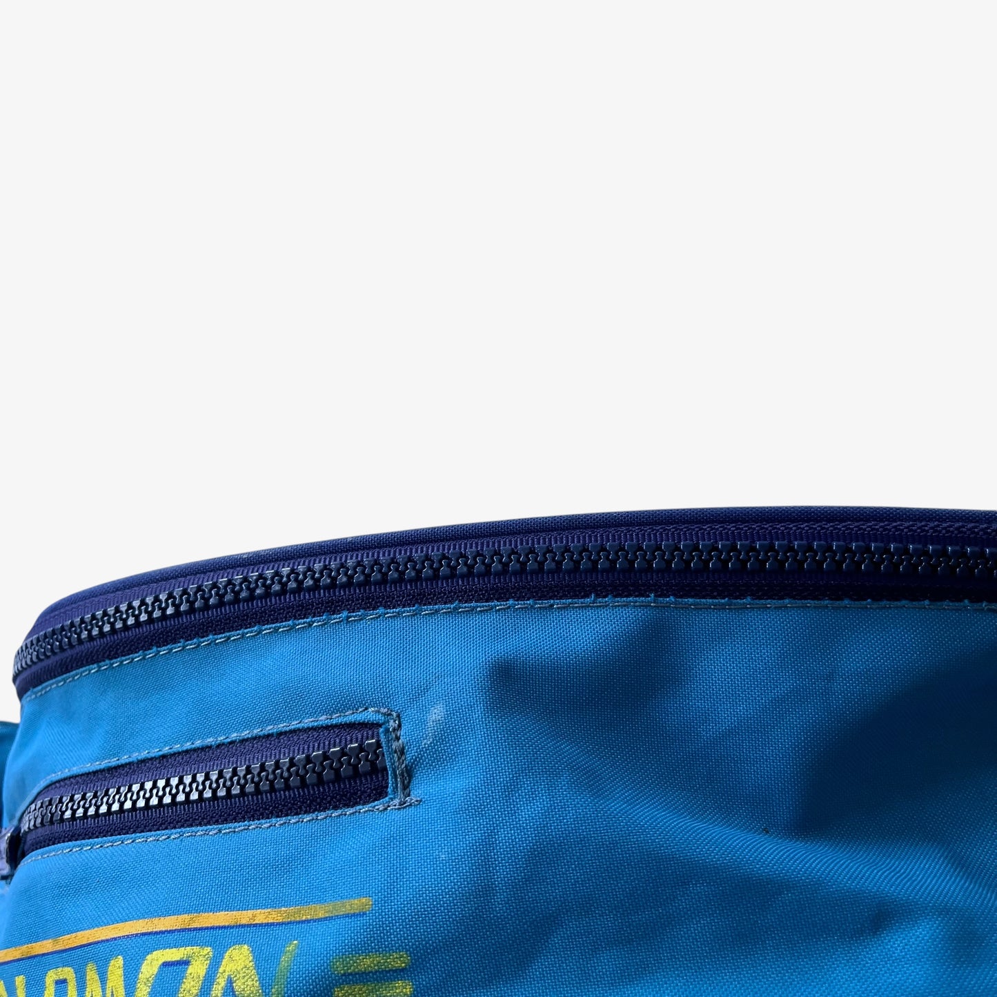 Close up of patina on a vintage Salomon blue bum bag.