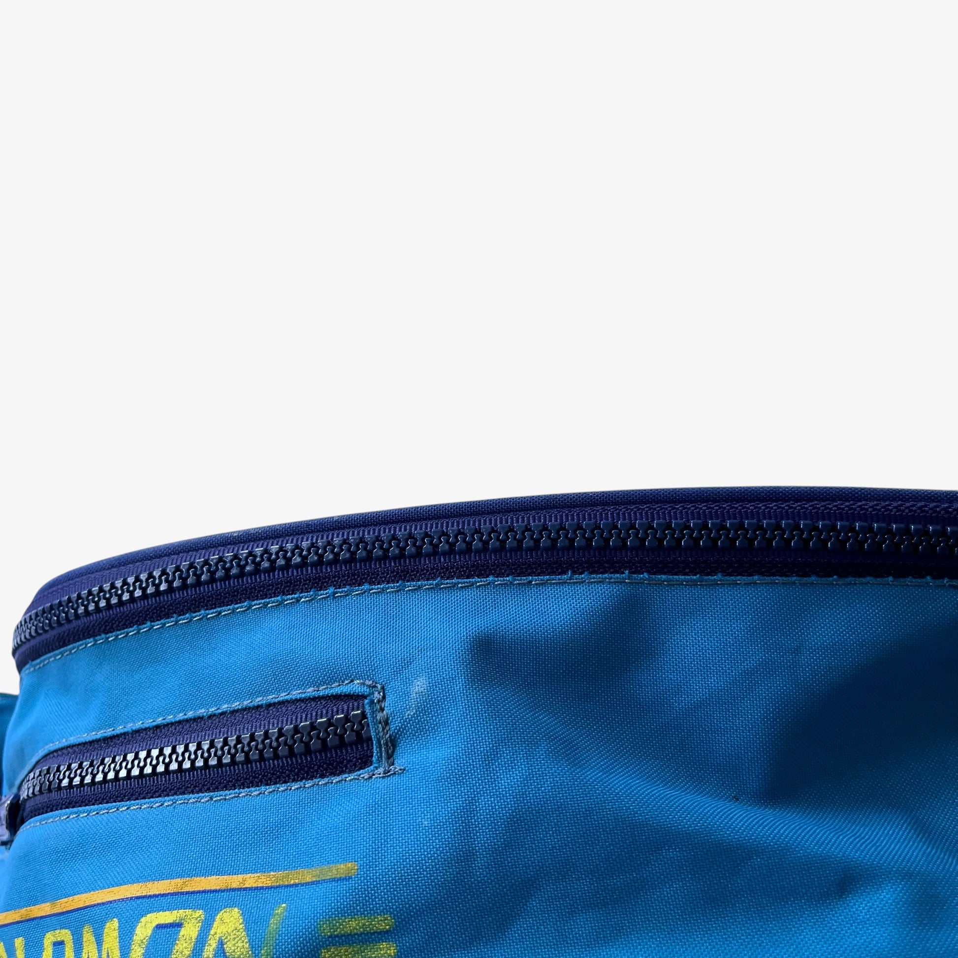 Close up of patina on a vintage Salomon blue bum bag.