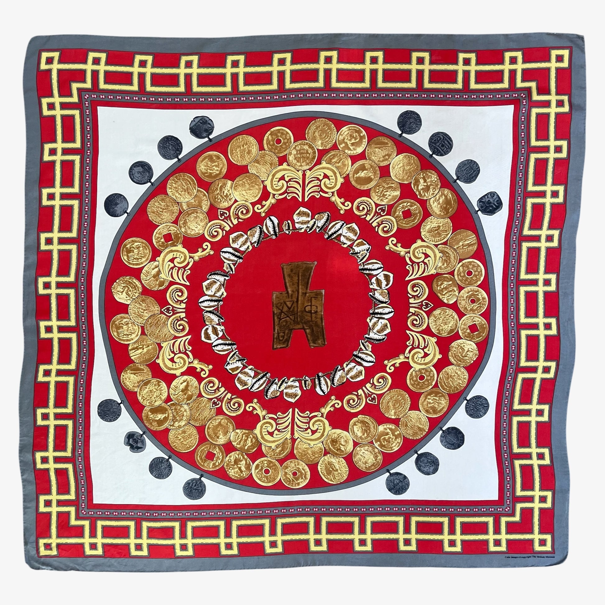 A square silk scarf featuring an intricate circular medallion design in red, gold, and white, framed by a grey border with a gold coin pattern.