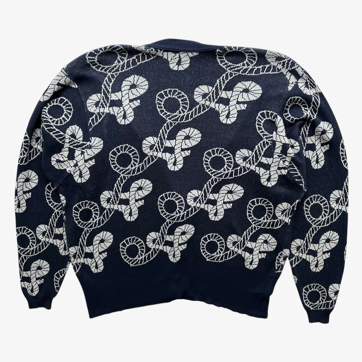 Back of vintage 80s women's Aquascutum navy nautical patterned cardigan with white pattern on a white background.