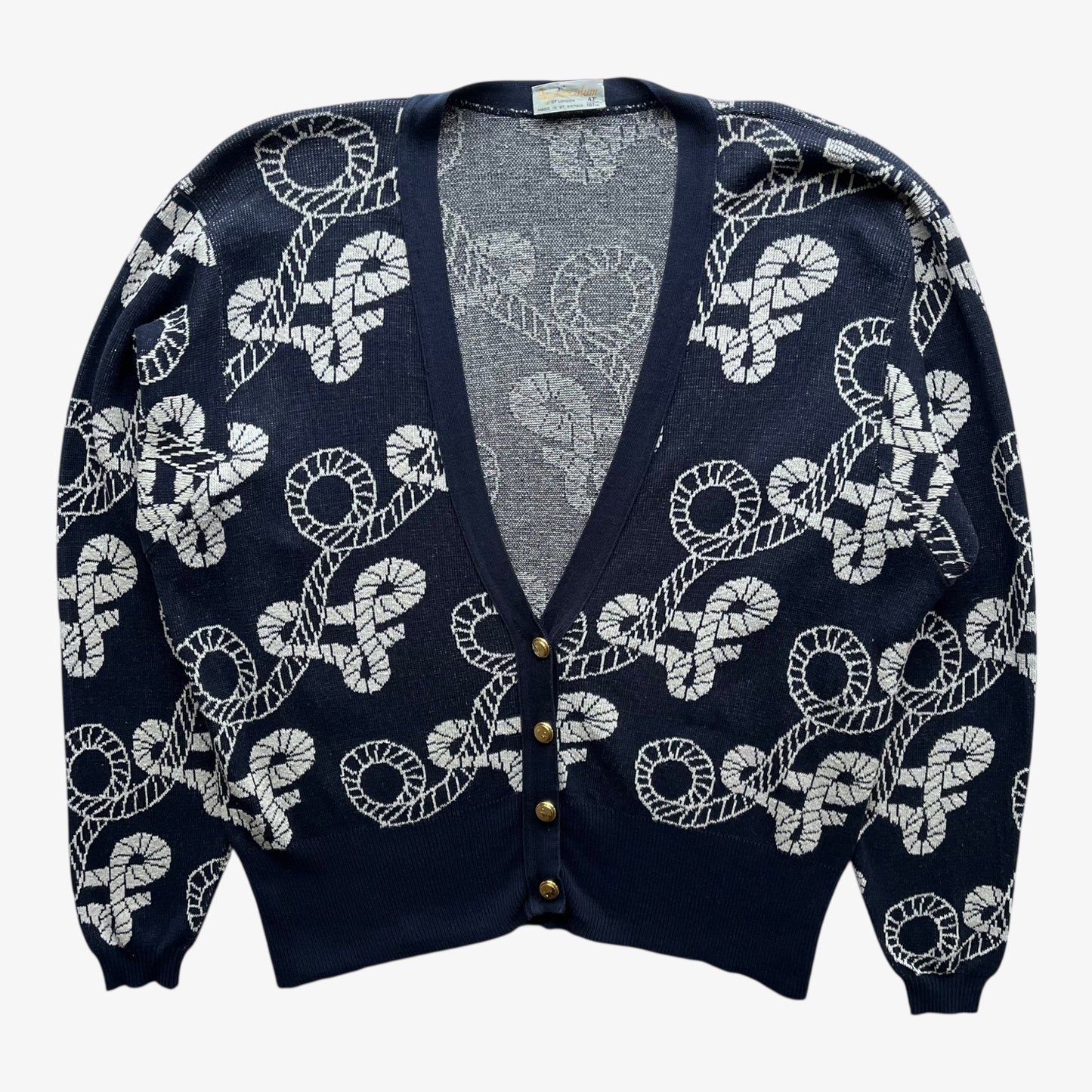 Vintage 80s women's Aquascutum navy nautical patterned cardigan with white pattern on a white background.