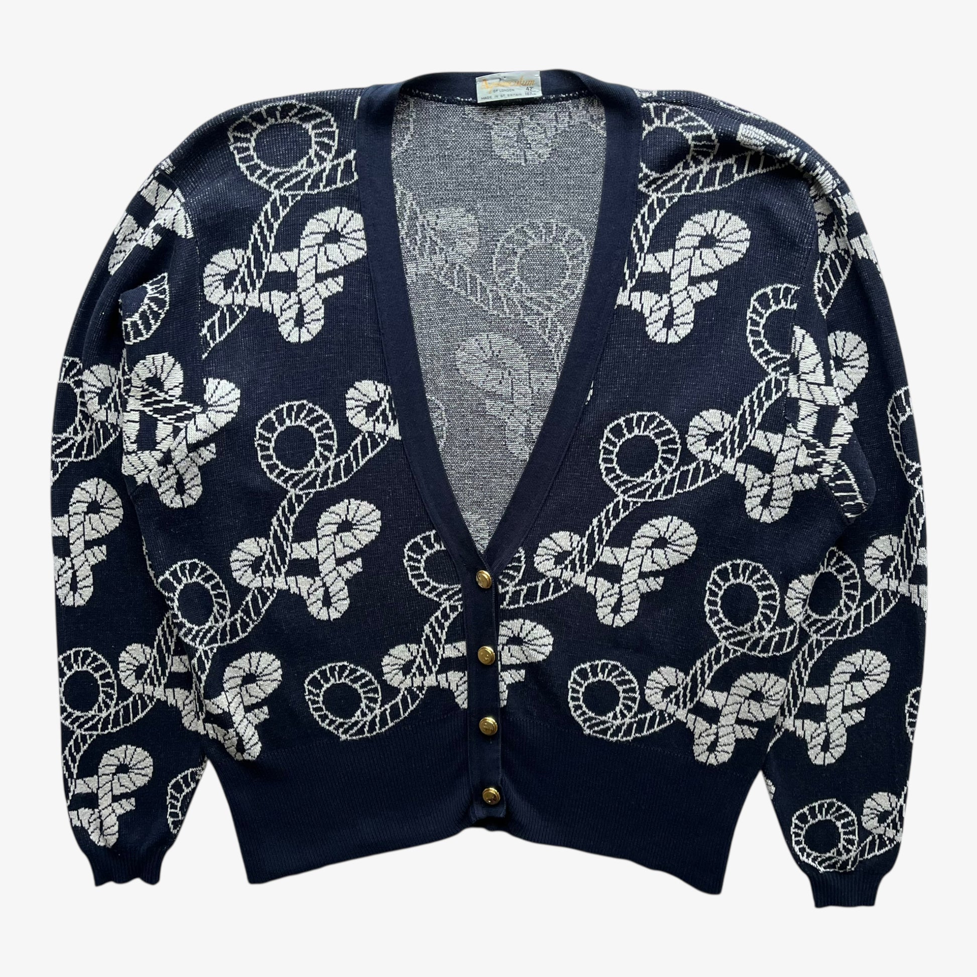Vintage 80s women's Aquascutum navy nautical patterned cardigan with white pattern on a white background.