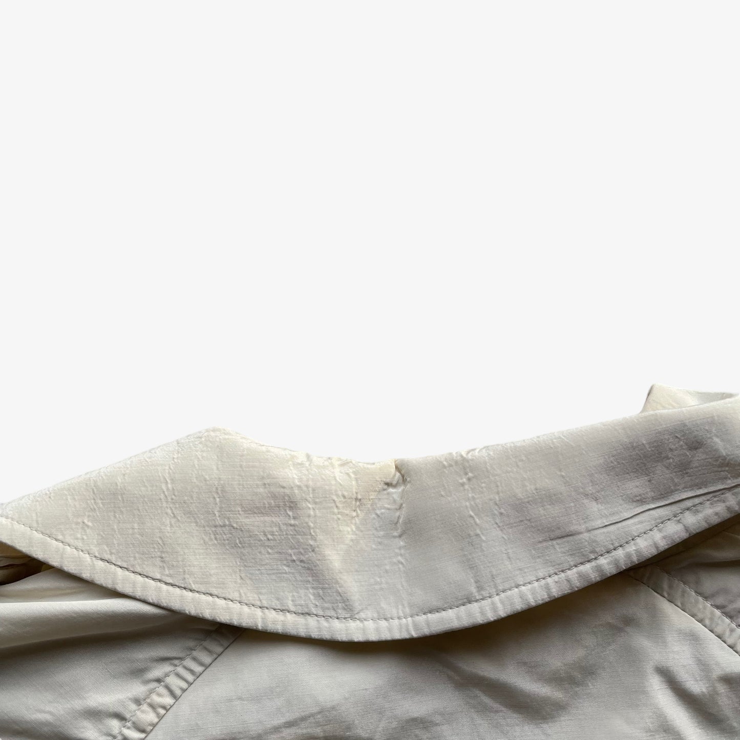 Collar of women's vintage 80s Burberry double breasted cream trench coat.