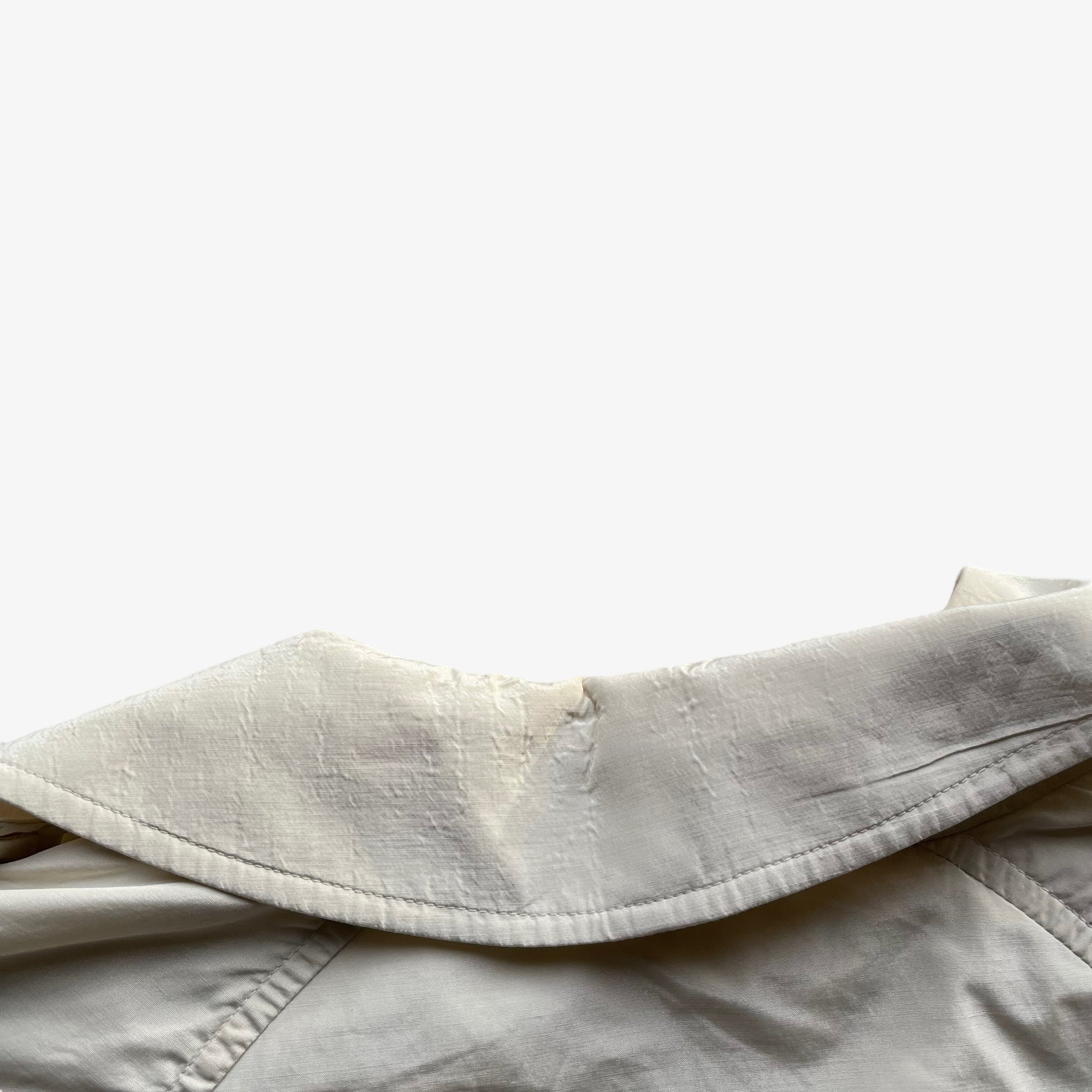 Collar of women's vintage 80s Burberry double breasted cream trench coat.
