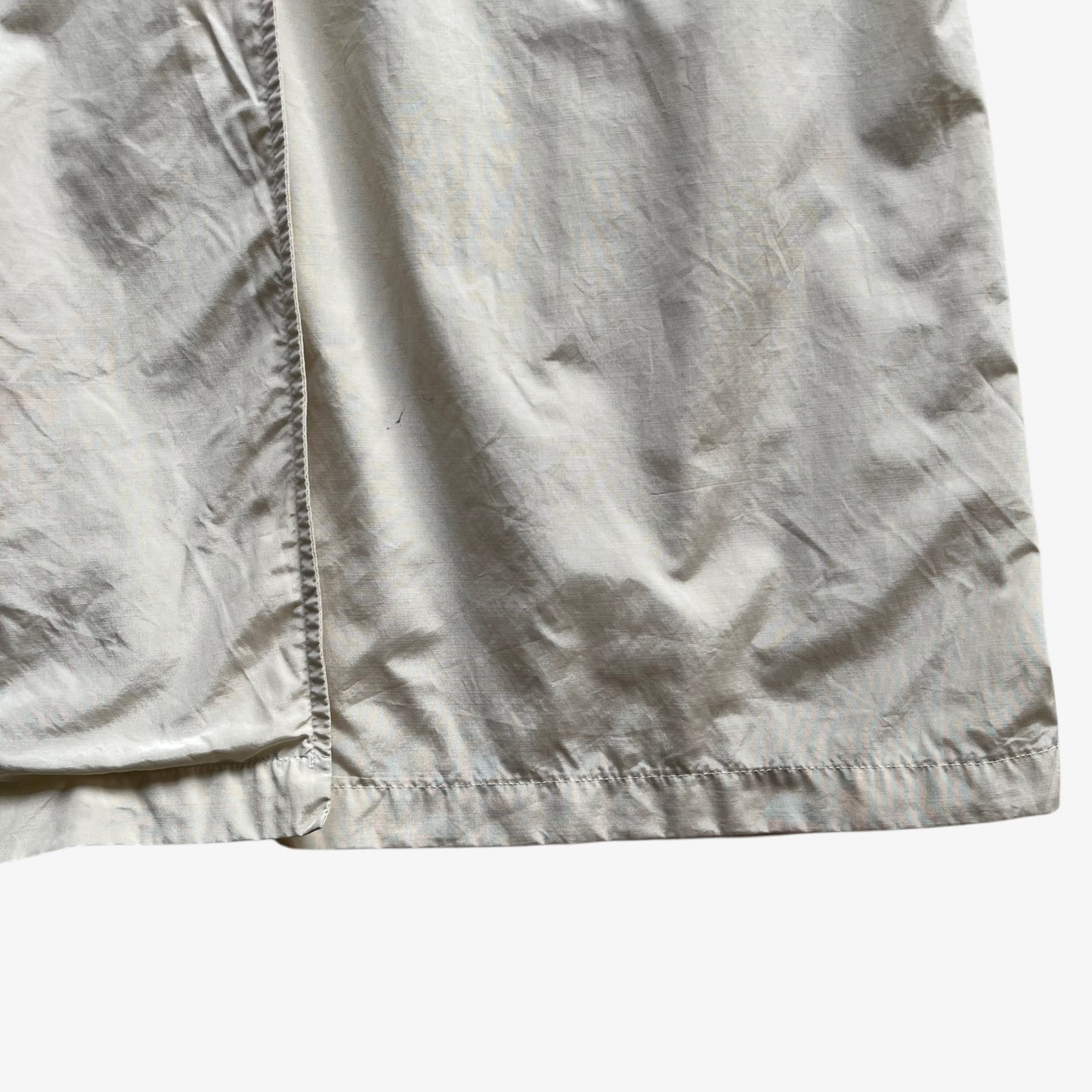 Hem of women's vintage 80s Burberry double breasted cream trench coat.