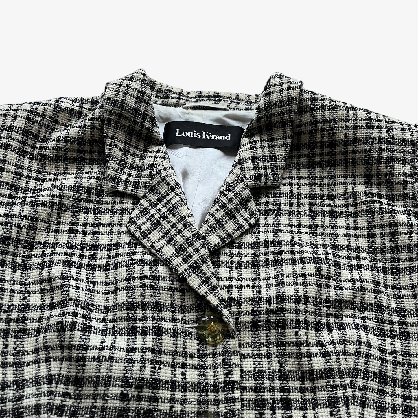 Close up of the cream and black striped on a vintage 80s women's Louis Feraud blazer.