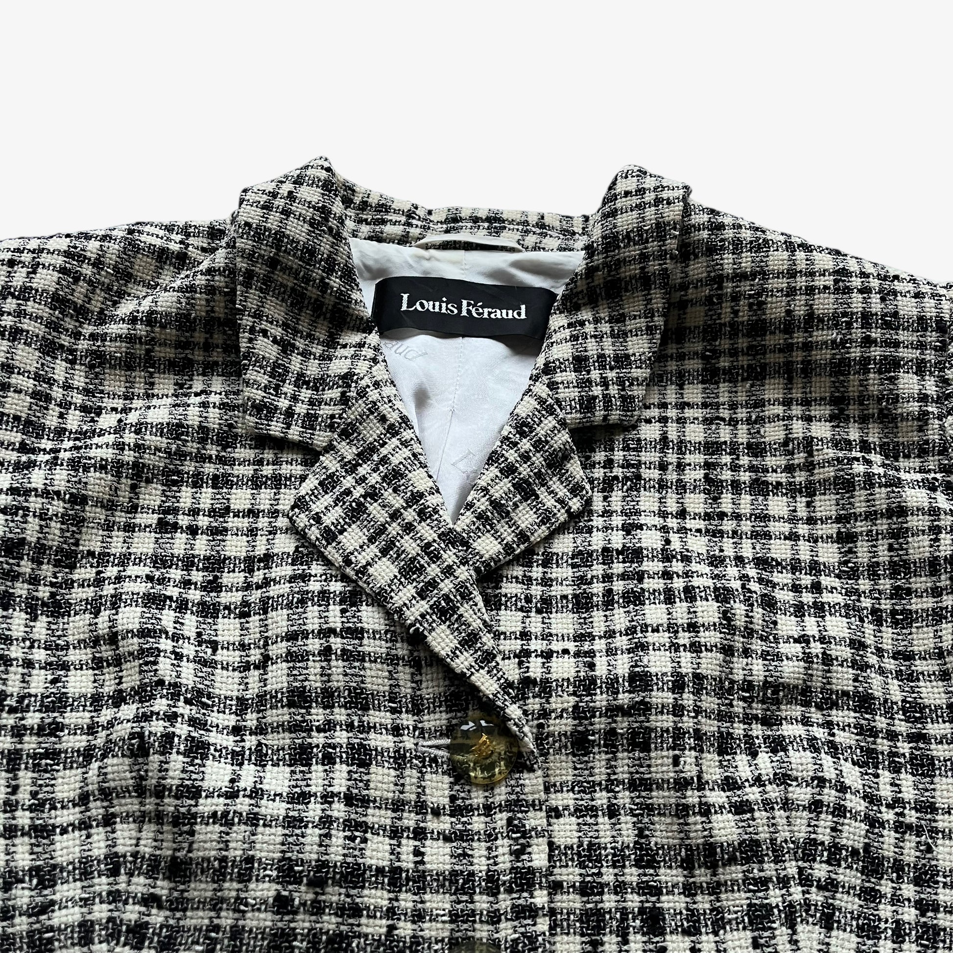 Close up of the cream and black striped on a vintage 80s women's Louis Feraud blazer.