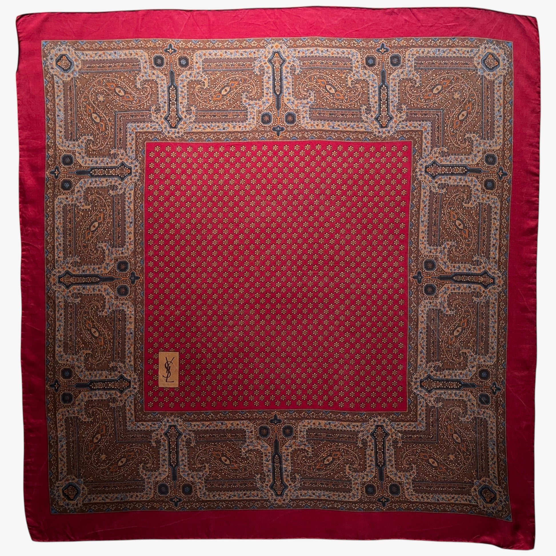 Women's vintage 80s Yves Saint Laurent foulards geometric paisley print red silk scarf with a big YSL logo.