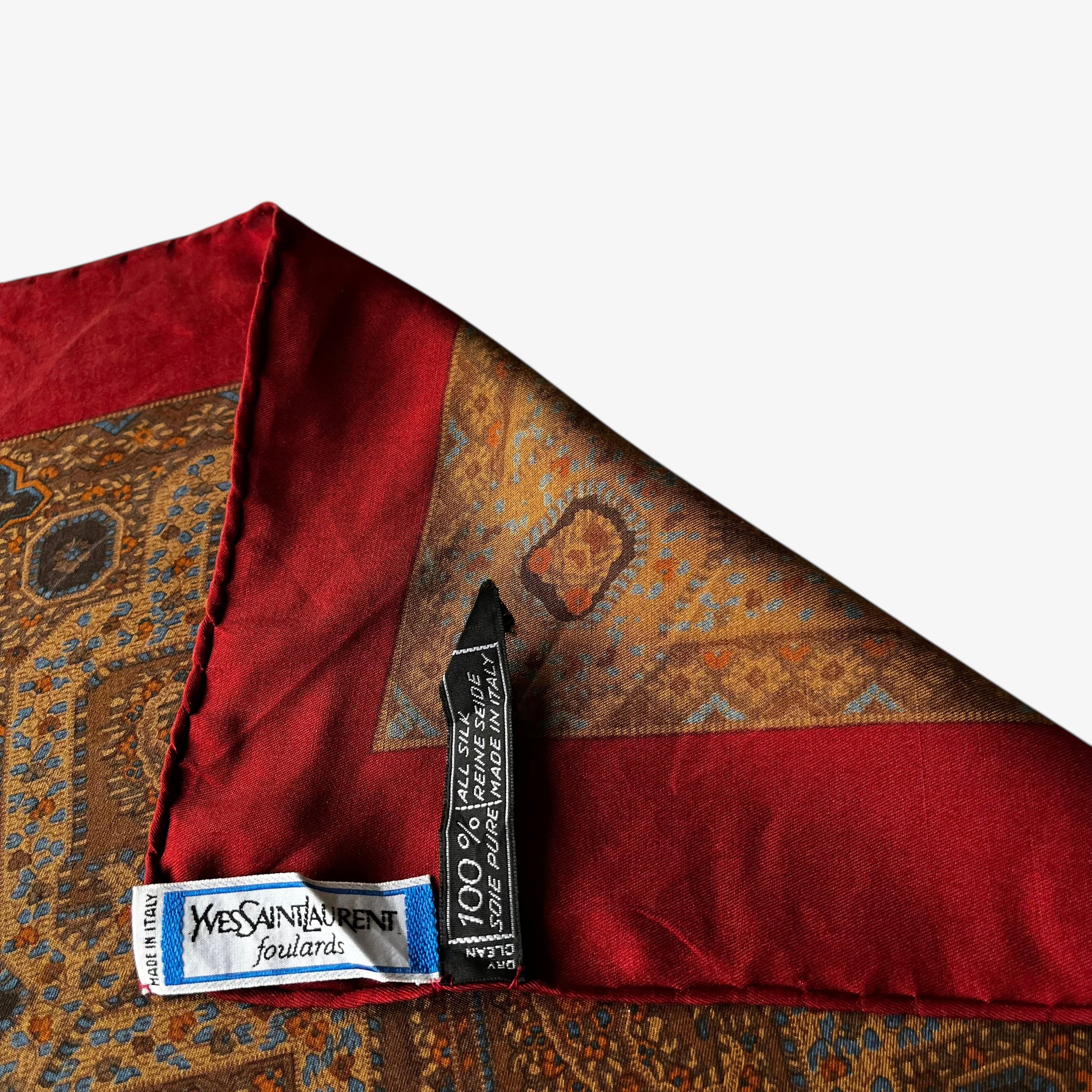 Yves Saint Laurent foulards pure silk label of women's vintage 80s geometric paisley print red scarf with a big YSL logo.