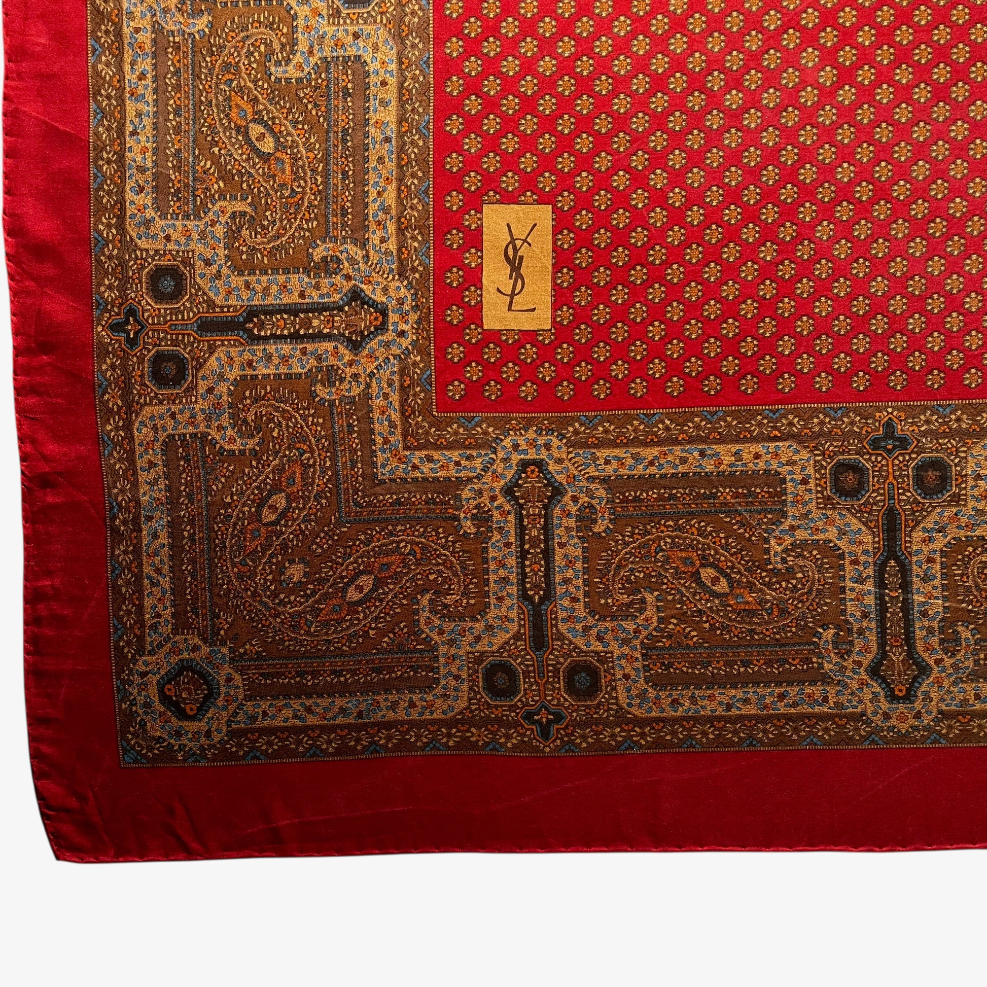 Big YSL printed logo on the bottom corner of women's vintage 80s Yves Saint Laurent foulards geometric paisley print red silk scarf.