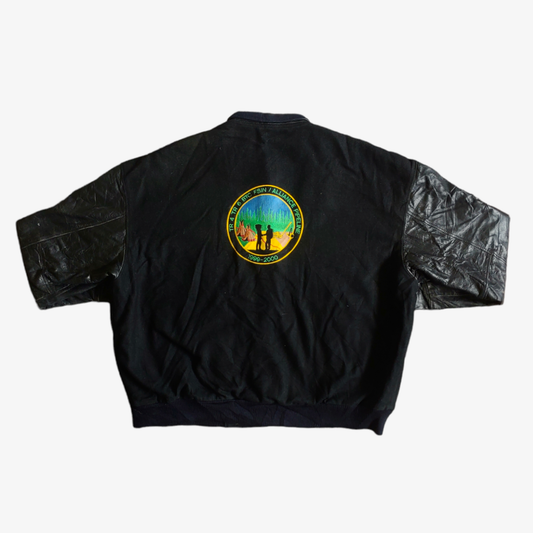 A black vintage leather varsity jacket with an embroidered chief logo on the back.