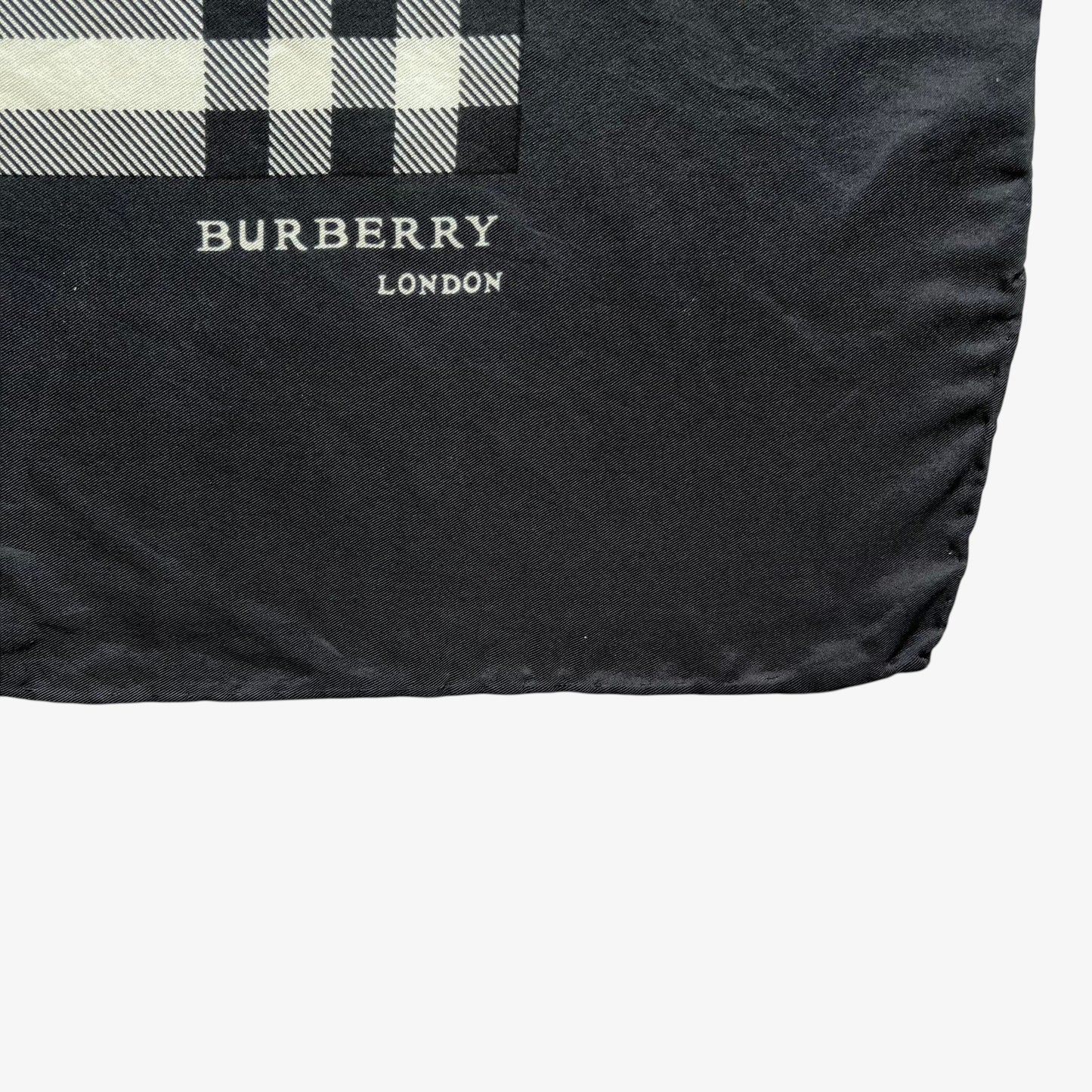 Burberry London spell out logo on women's vintage 90s black nova check print silk scarf.