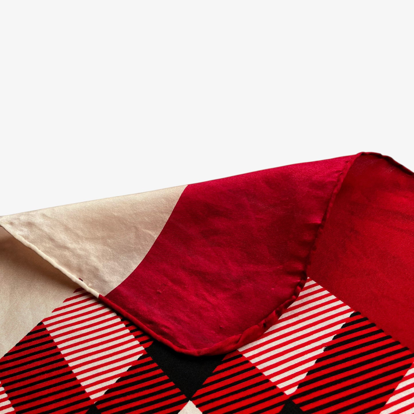 Hand rolled edges of vintage 90s women's Burberry red nova check print silk scarf featuring a colourful plaid tartan pattern.