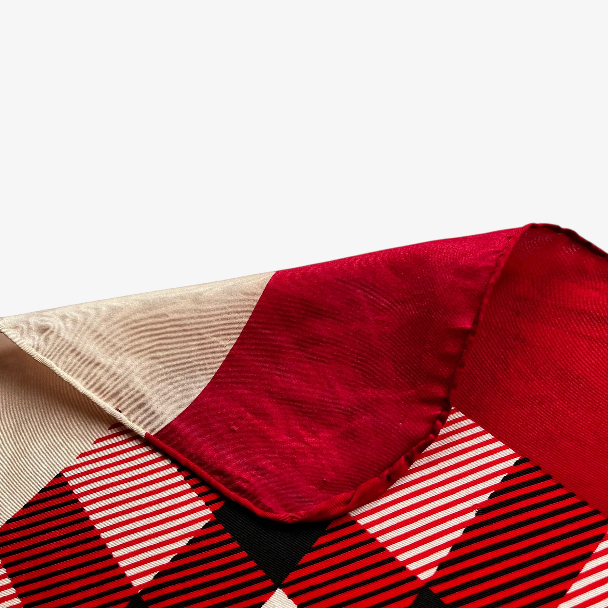 Hand rolled edges of vintage 90s women's Burberry red nova check print silk scarf featuring a colourful plaid tartan pattern.