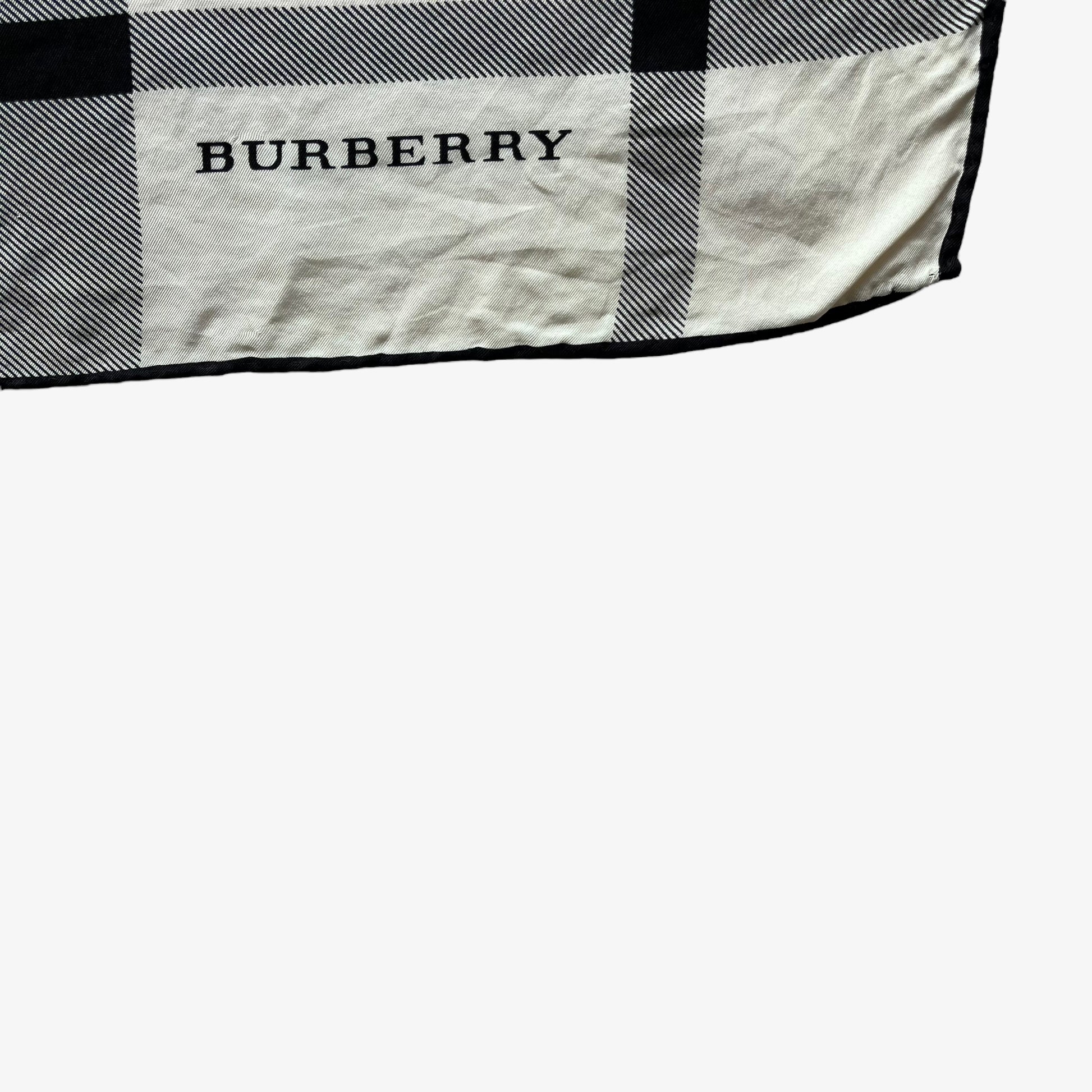 Burberry spell out logo on women's vintage 90s white and black nova check print silk scarf.