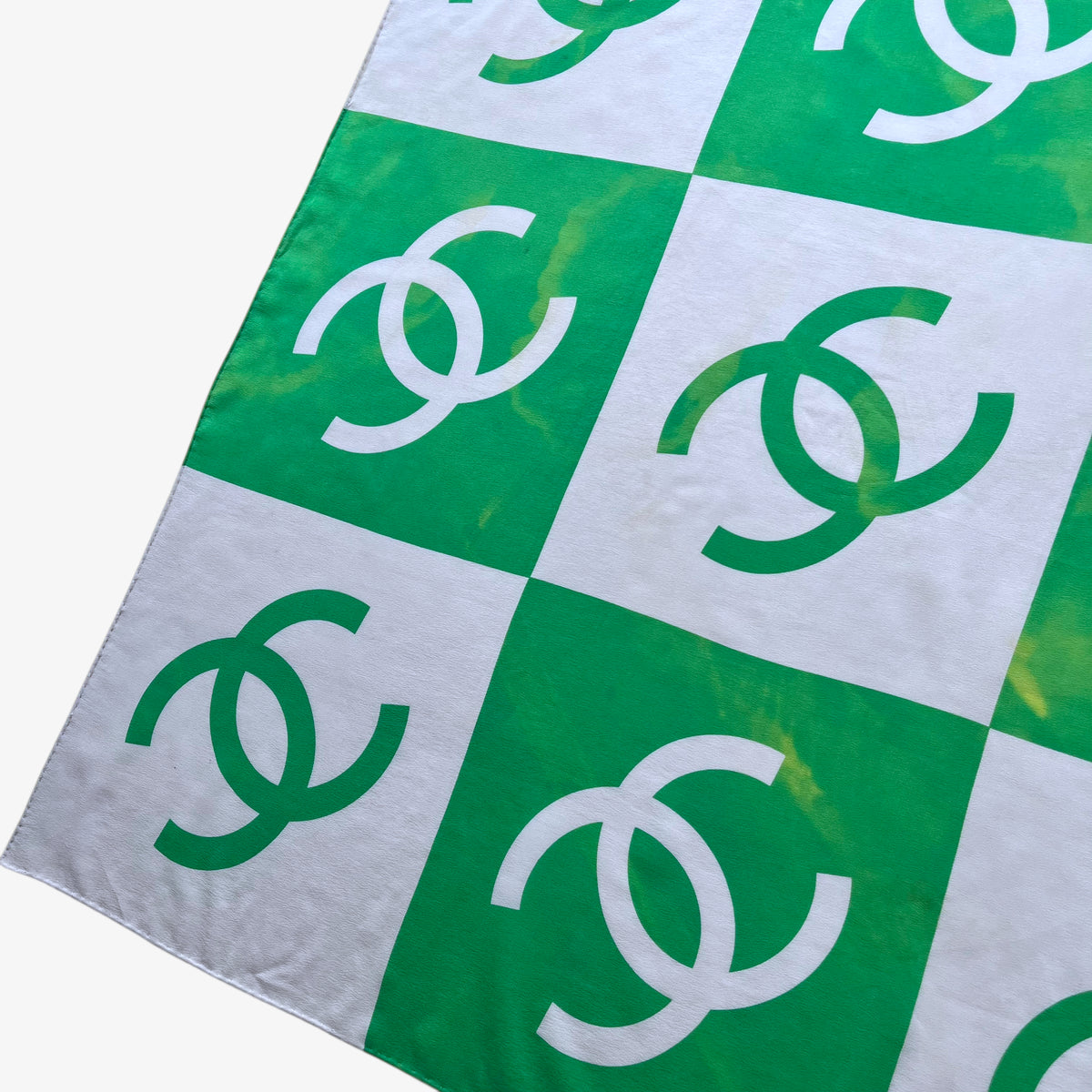 Fading green colour of women's vintage 90s Chanel interlocking CC checkered print silk scarf.