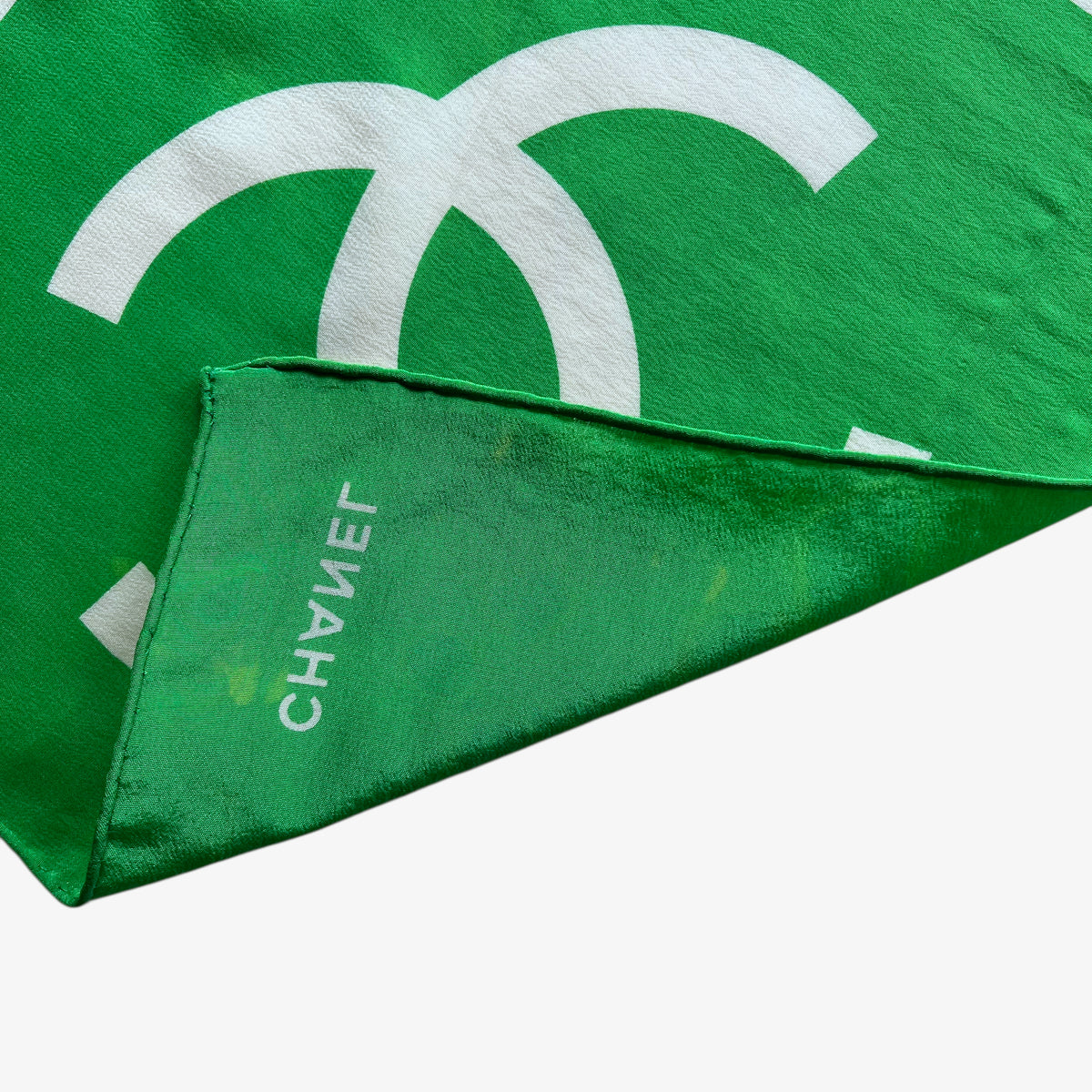 Hand rolled edges of women's vintage 90s Chanel interlocking CC checkered print green silk scarf.
