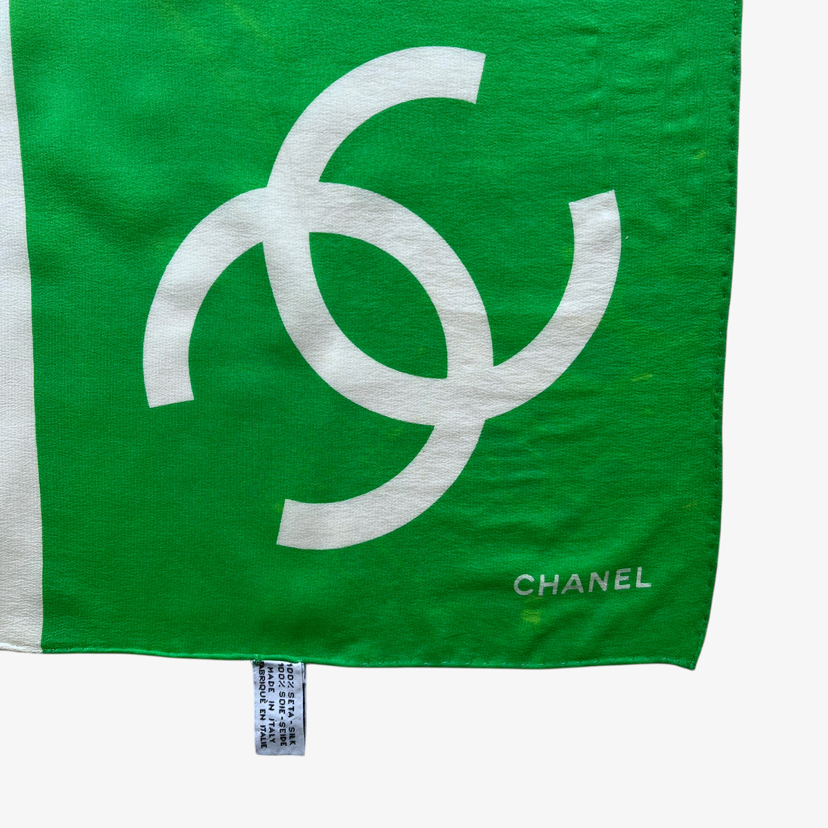 Made in Italy label on women's vintage 90s Chanel interlocking CC checkered print green silk scarf.