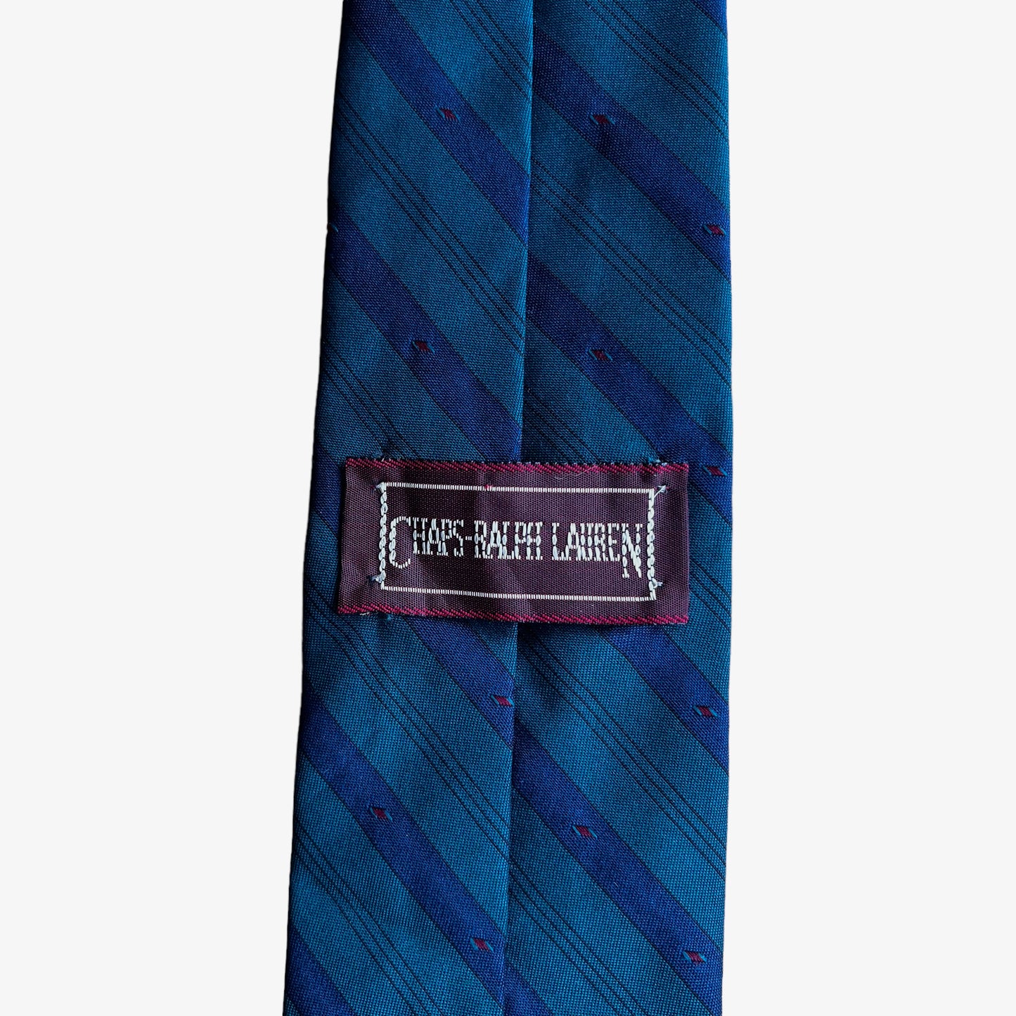 Label of vintage 90s Chaps Ralph Lauren green and blue striped silk blend tie.