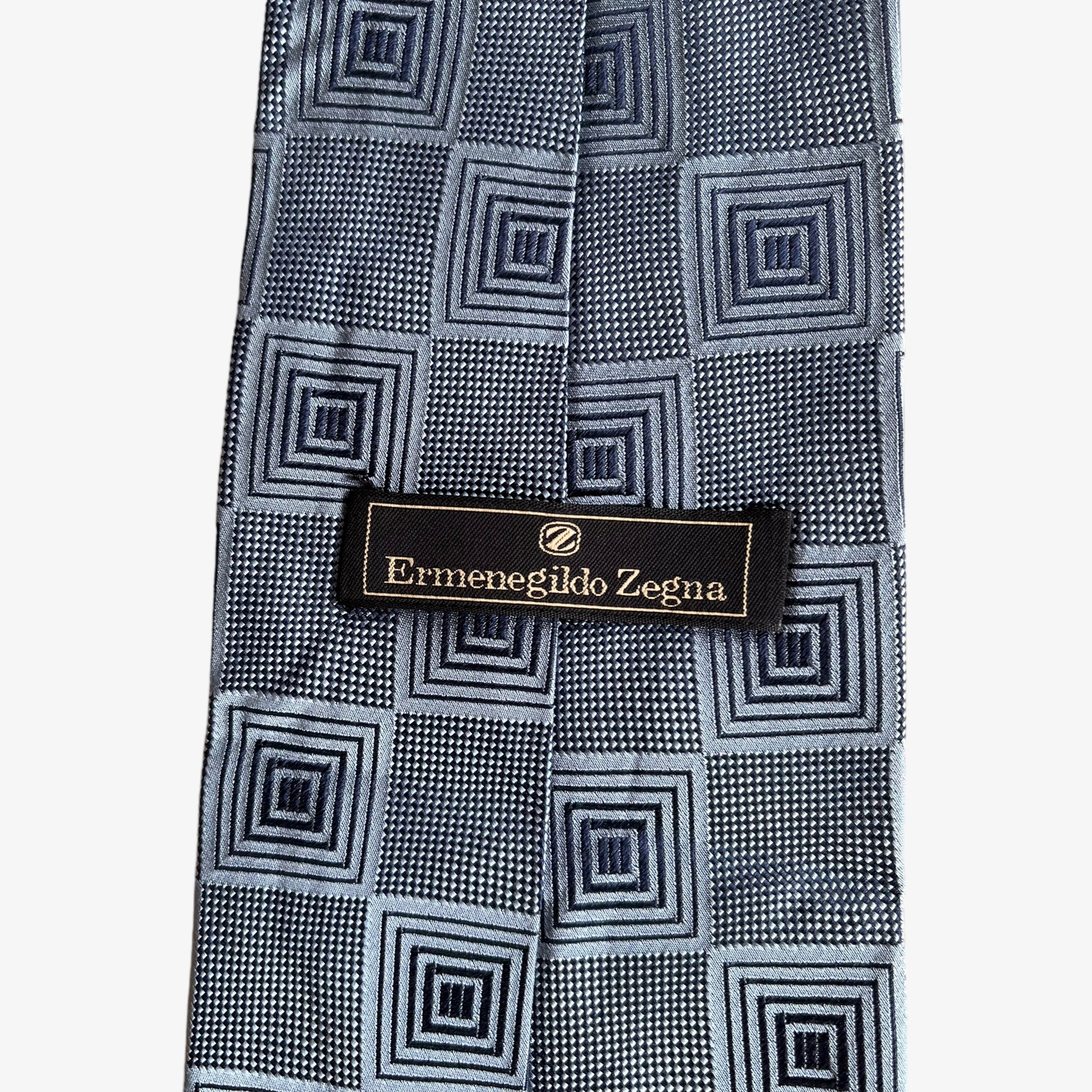 Label of vintage 90s Ermenegildo Zegna geometric abstract print silver silk tie.
