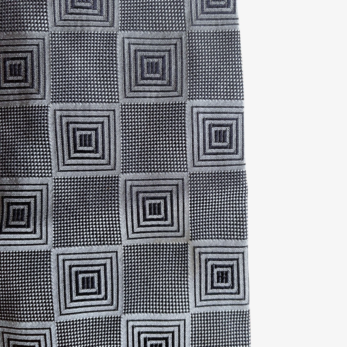 Wear on a vintage 90s Ermenegildo Zegna geometric abstract print silver silk tie.