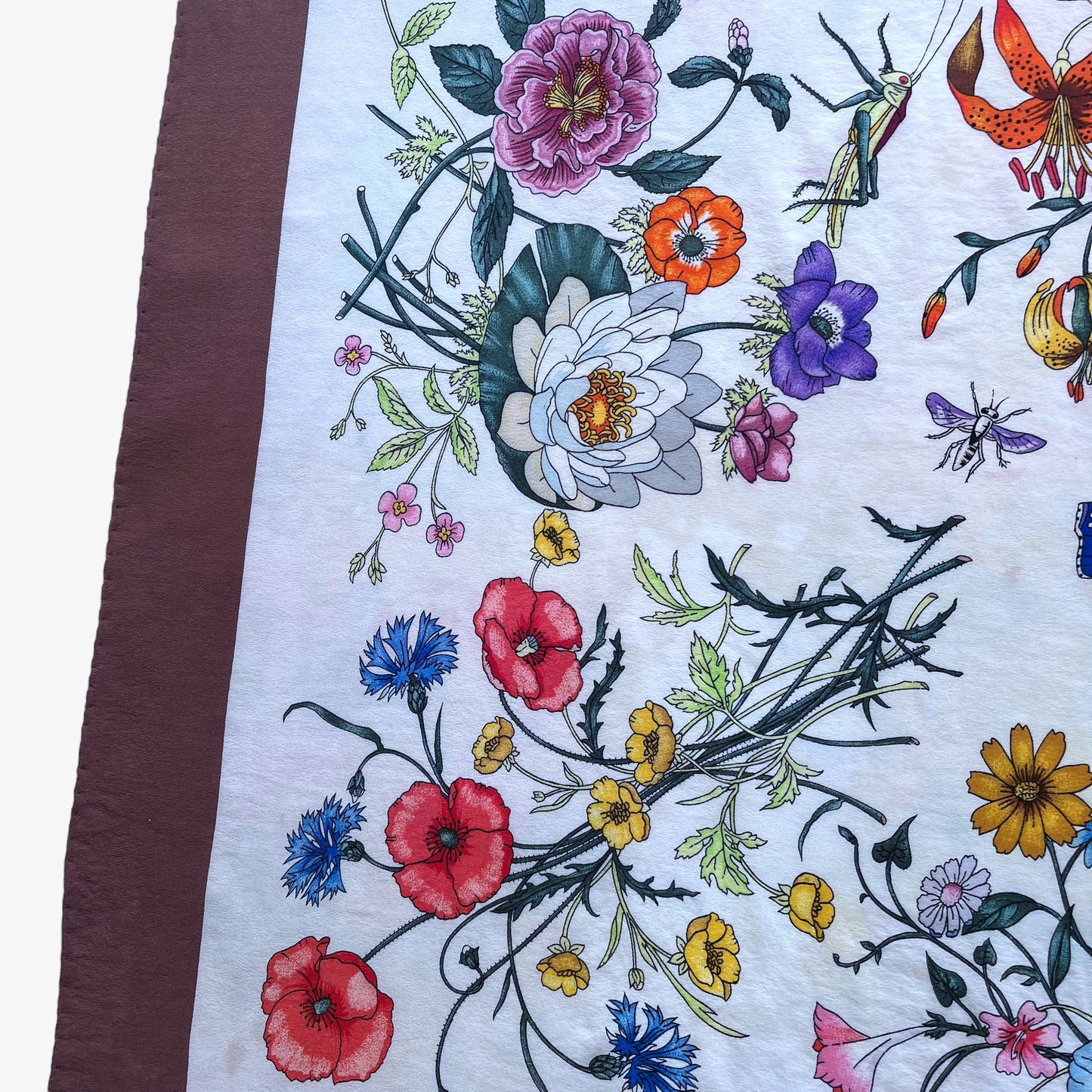 Colourful botanical pattern on women's 90s vintage Gucci insect print brown silk scarf designed by Vittorio Accornero.