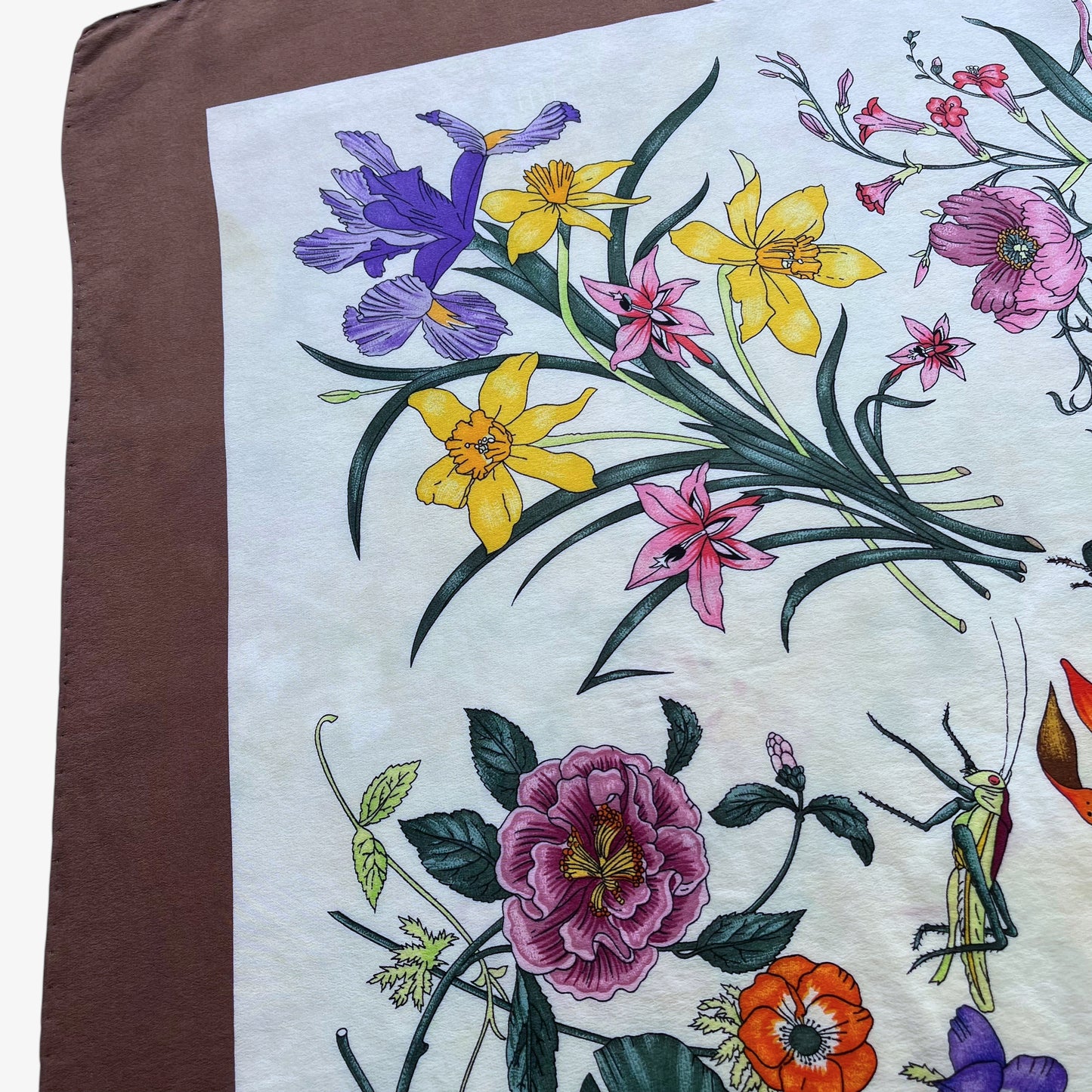 Colourful floral pattern on women's 90s vintage Gucci insect print brown silk scarf designed by Vittorio Accornero.