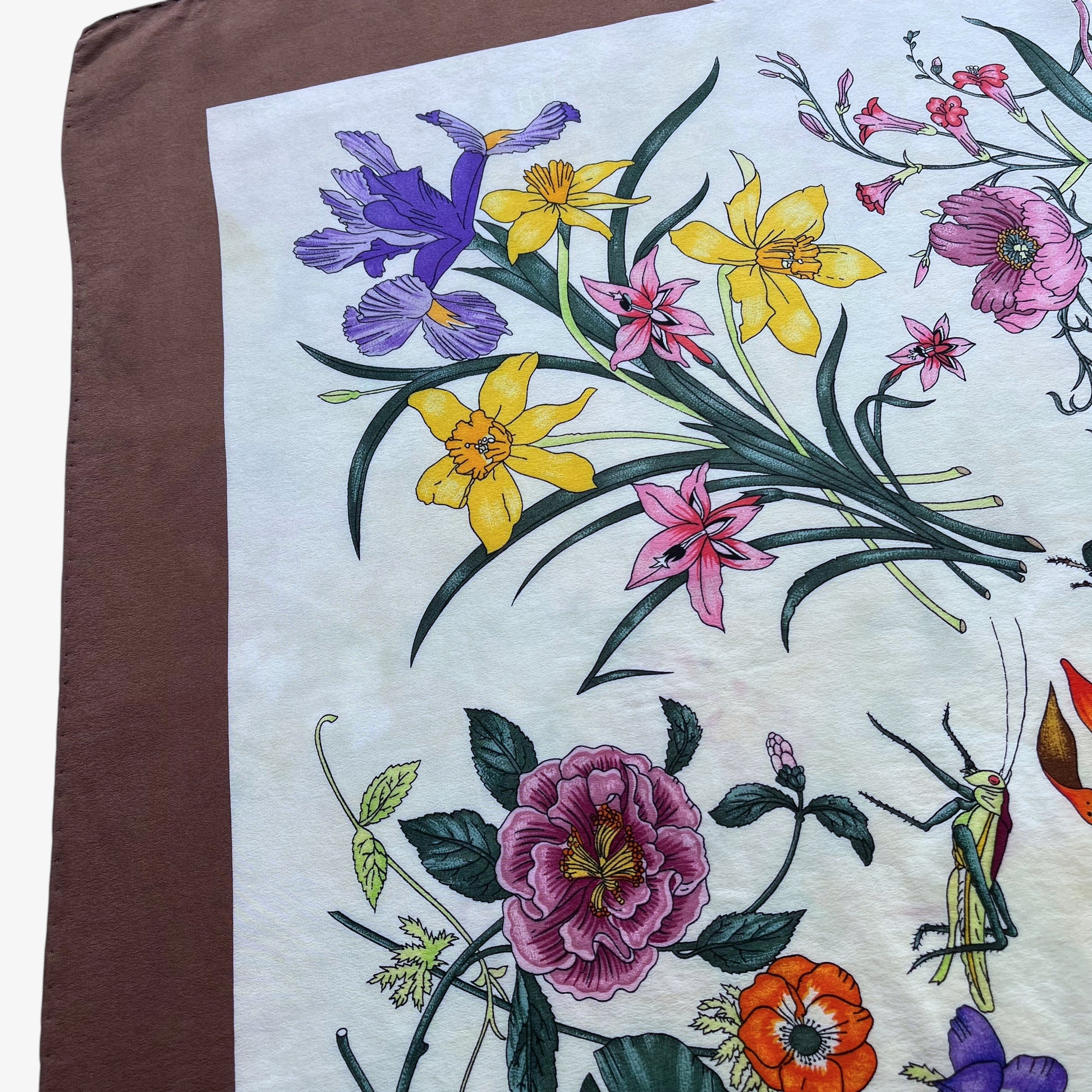 Colourful floral pattern on women's 90s vintage Gucci insect print brown silk scarf designed by Vittorio Accornero.